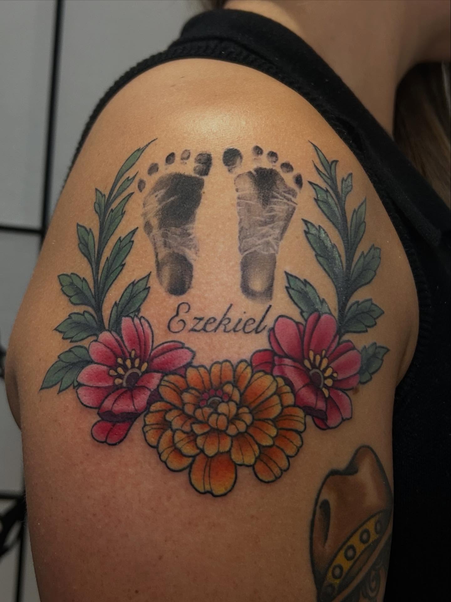 Baby footprints with floral wreath dotwork tattoo on the shoulder by Chloe