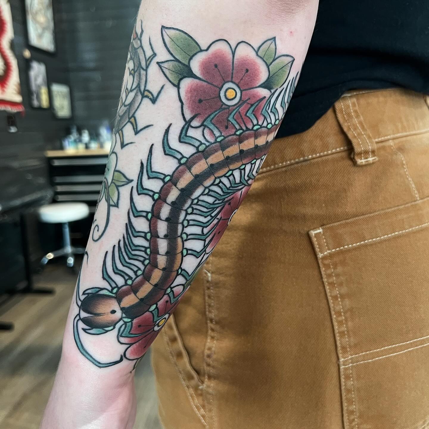 Centipede and flowers American traditional tattoo on the forearm by Kyle Olson, Salt Lake City, Utah
