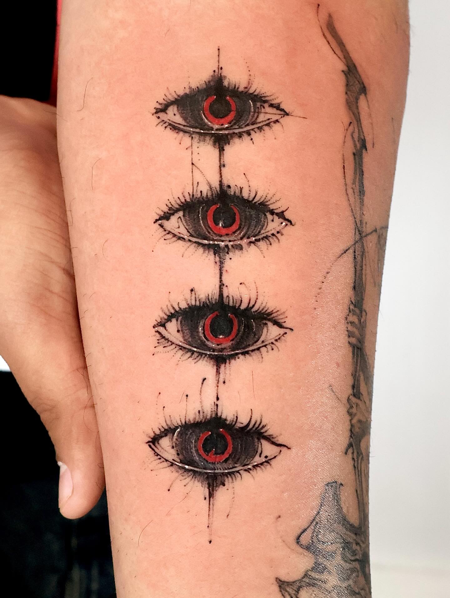 Eyes dotwork tattoo on the forearm by Tadi