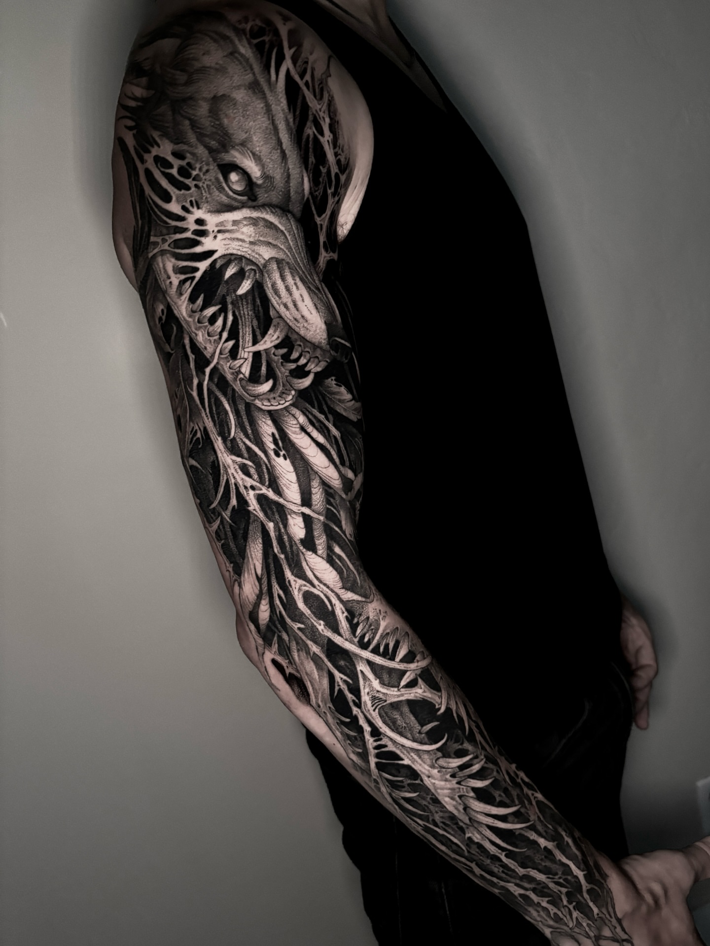 Monster dark realism tattoo on the upper arm by Jens