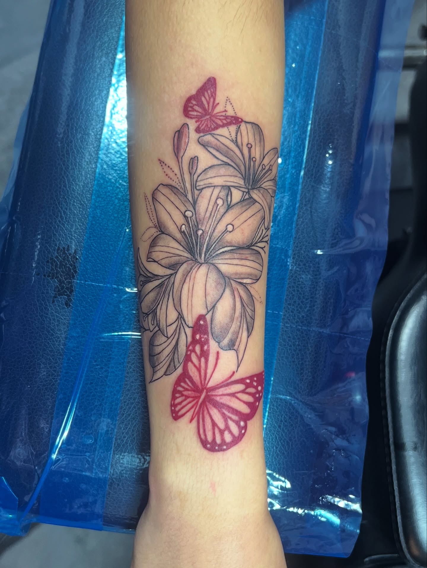 Flowers and butterflies black and grey tattoo on the forearm by CandiCoatedInk