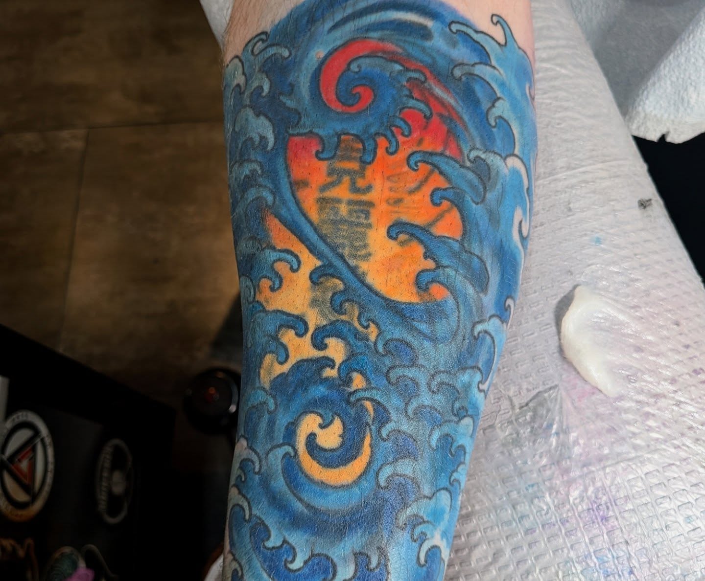 Waves and flame japanese irezumi tattoo on the forearm by Nic Skrade, Minneapolis, Minnesota