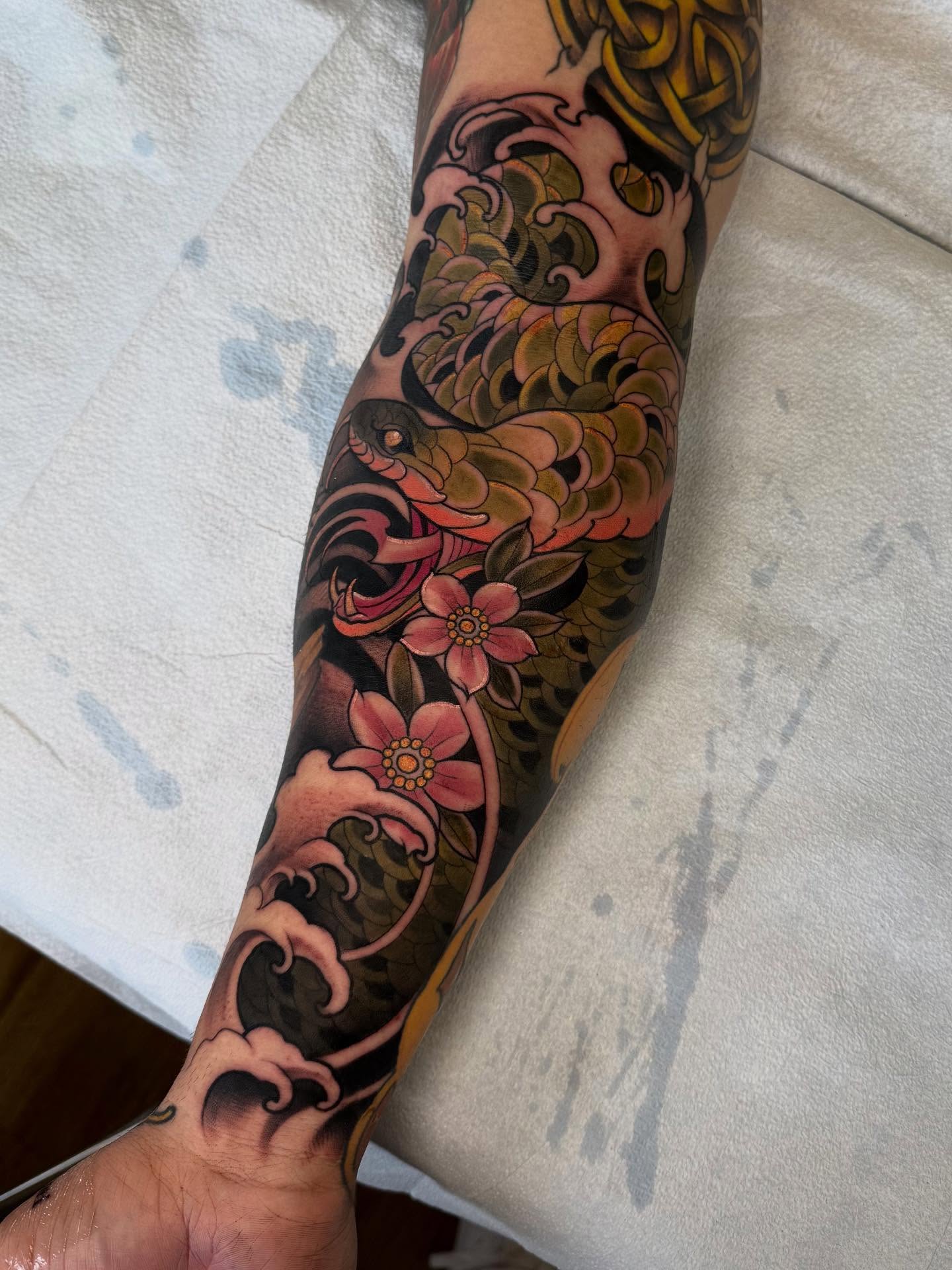 Wave and flowers japanese irezumi tattoo on the forearm by Bryan ๐ฅ Loggins, Baton Rouge, Louisiana