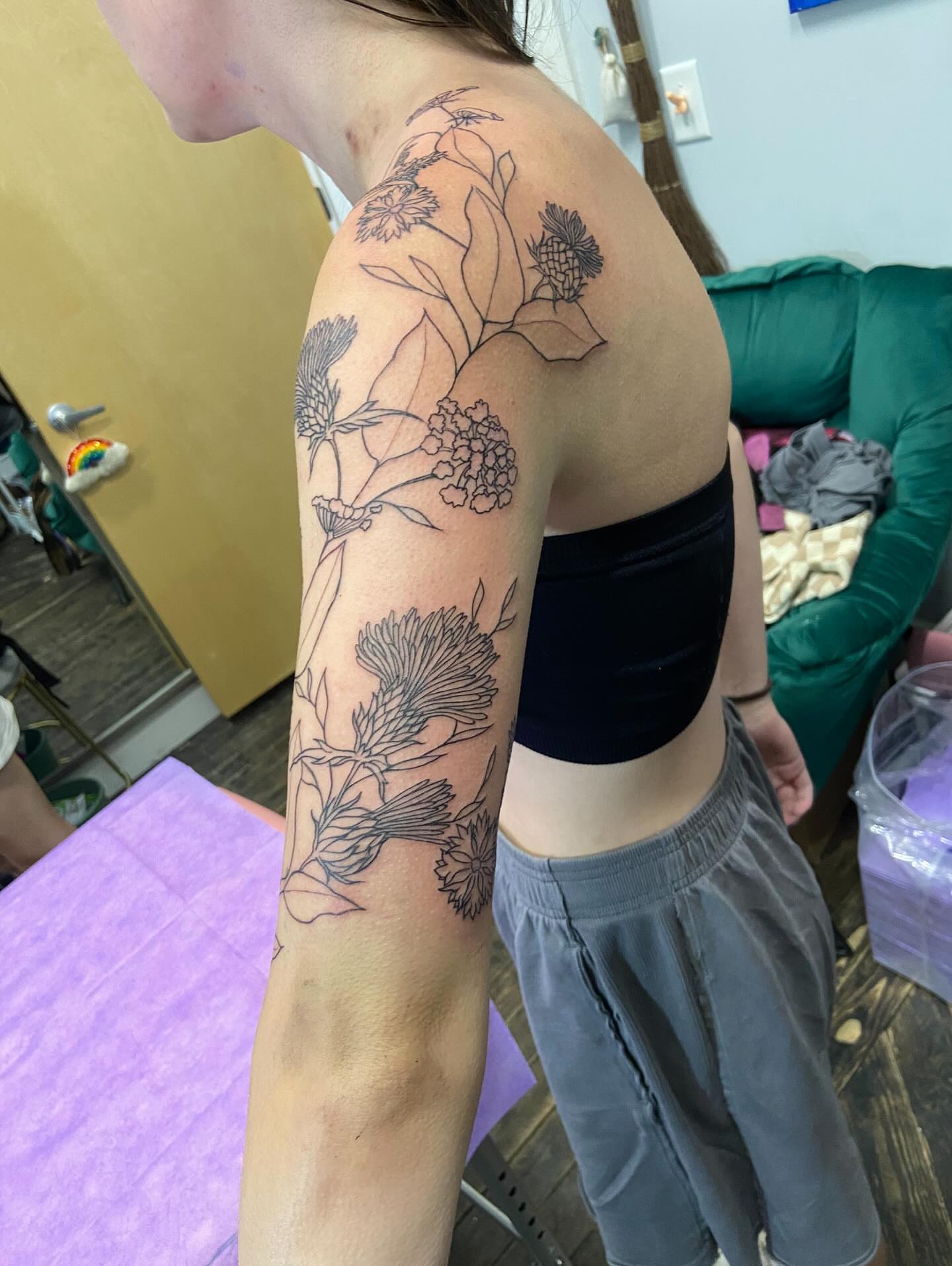 Botanical black and grey tattoo on the upper arm by Dont Worry About It