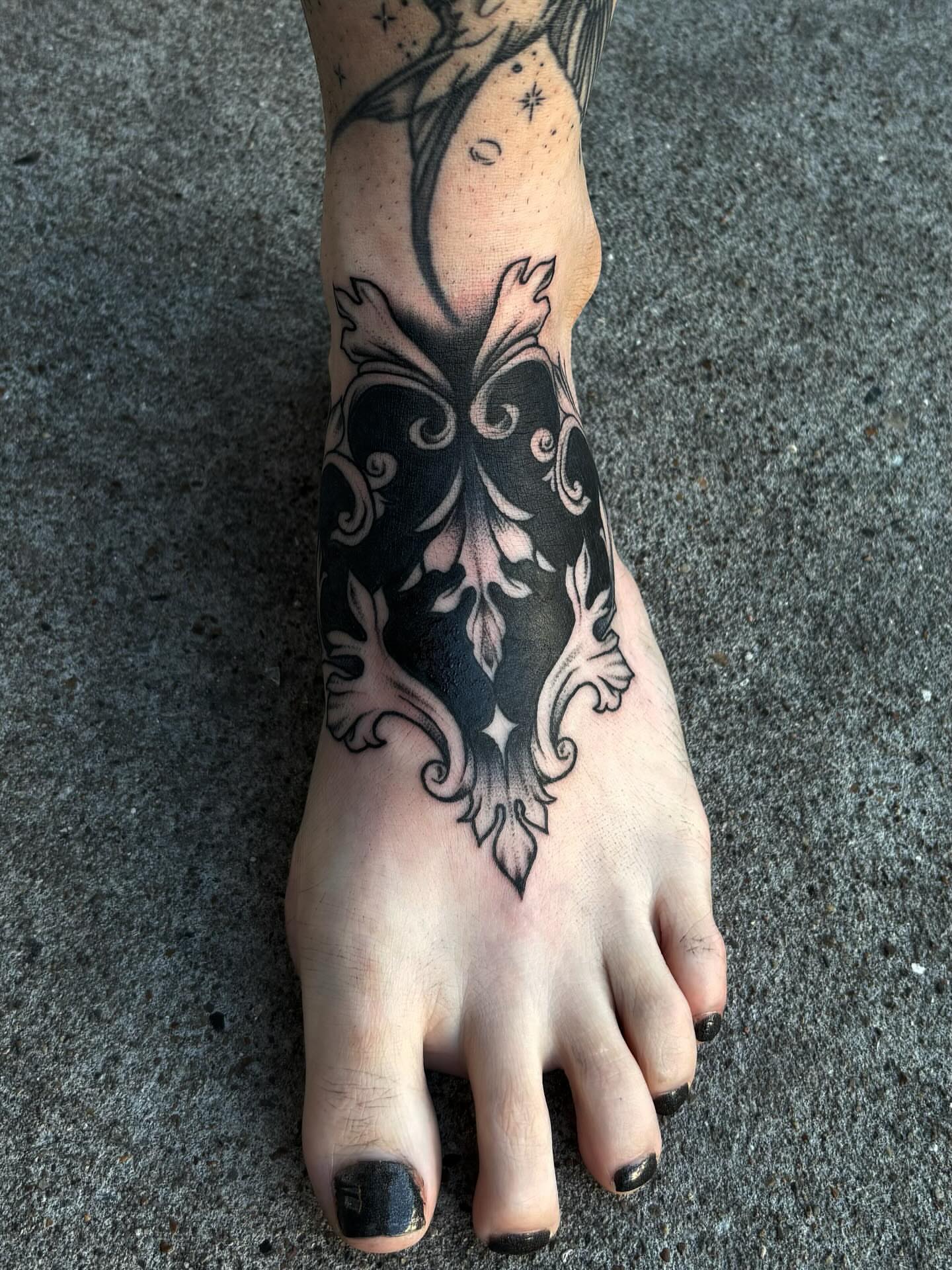 Ornamental design ornamental tattoo on the foot by Brett Ferguson