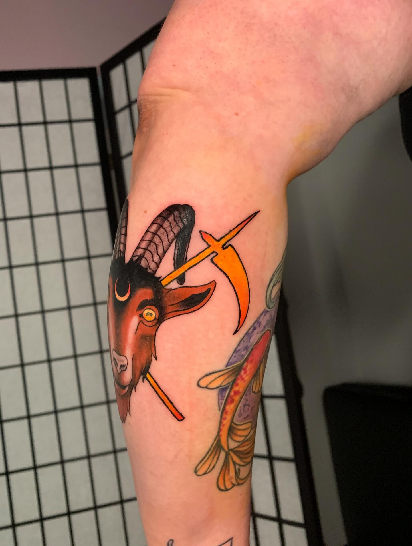 Goat and koi fish new school tattoo on the forearm by Devon