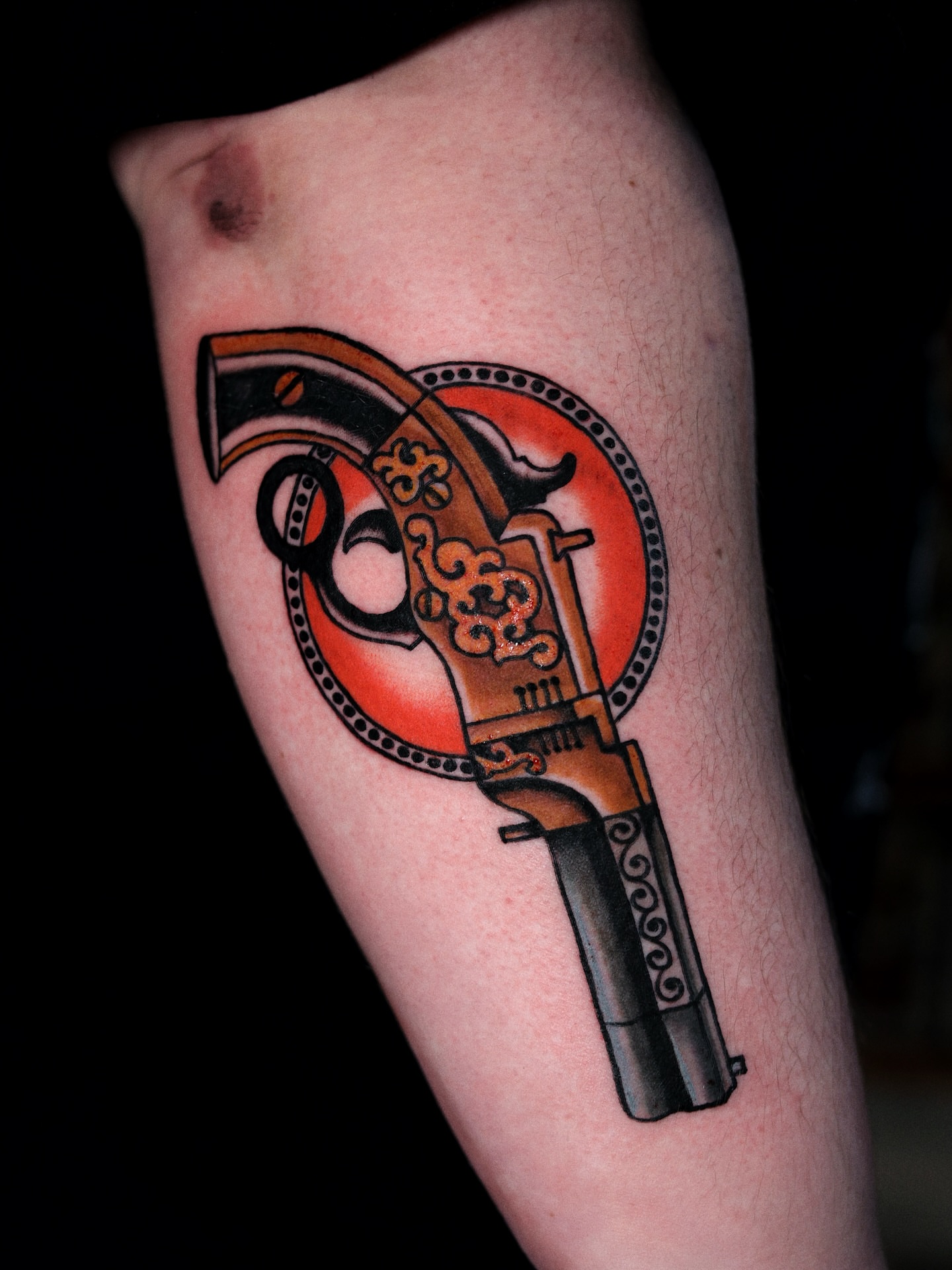 Revolver American traditional tattoo on the forearm by Dylan Mott