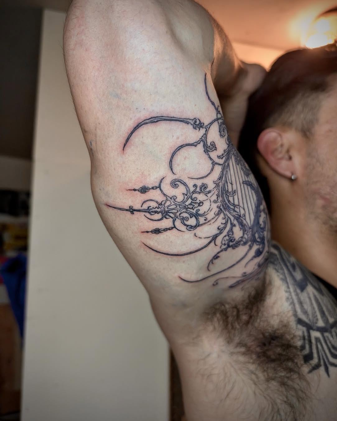 Abstract design ornamental tattoo on the forearm by Quin Walker