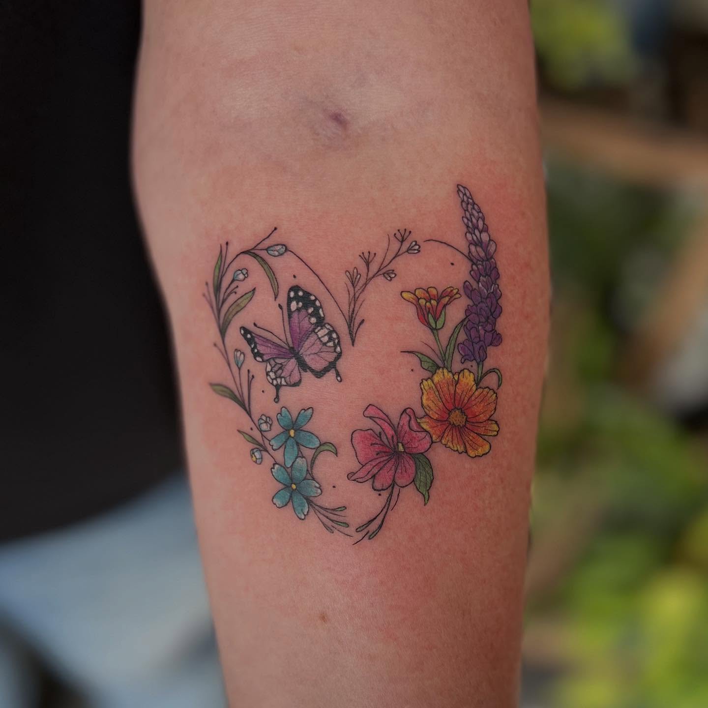 Butterfly and flowers new school tattoo on the forearm by 𝖑𝖎𝖑 𝖗𝖎𝖘𝖘