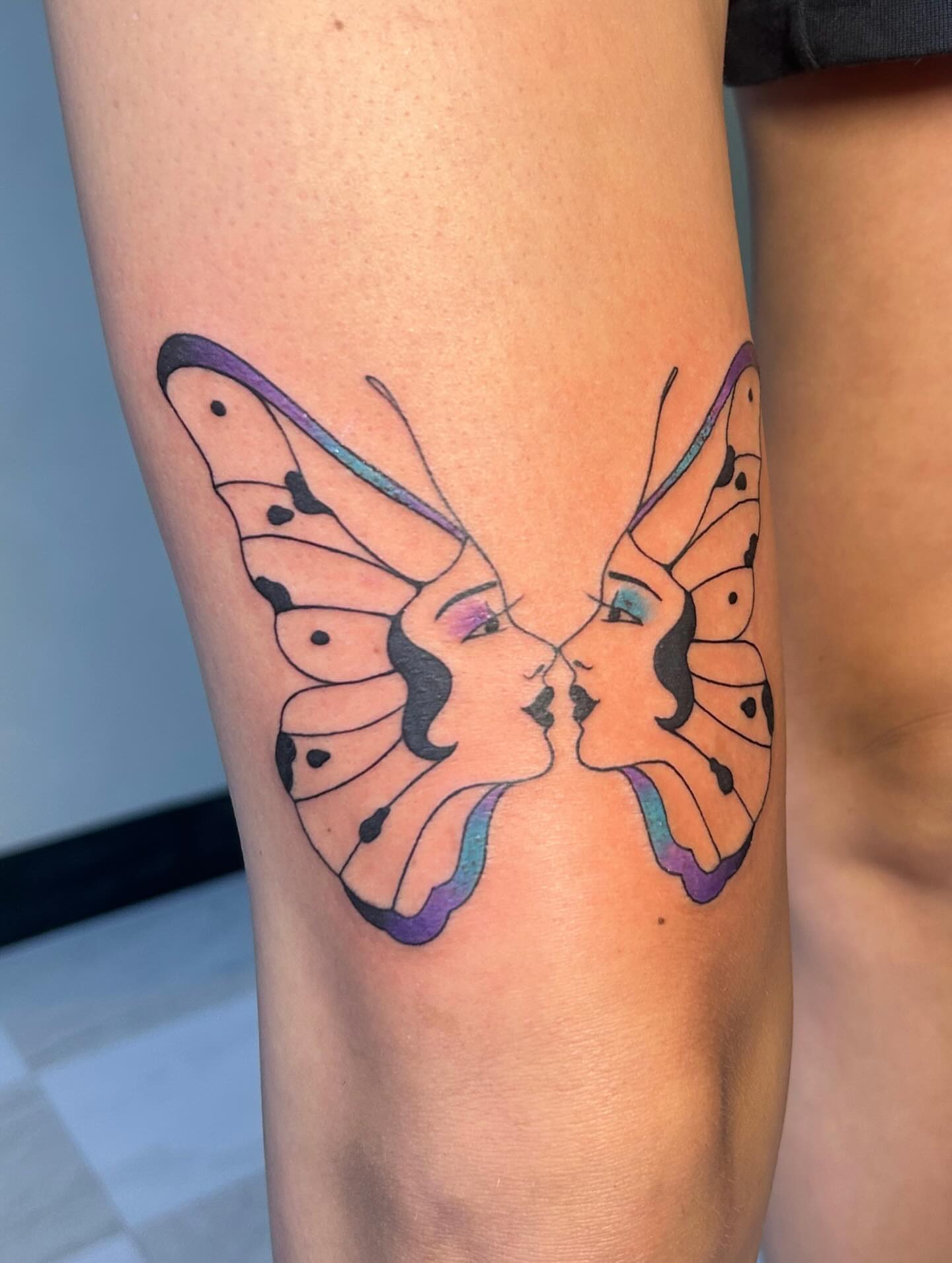 Butterfly faces geometric tattoo on the forearm by kuna ink