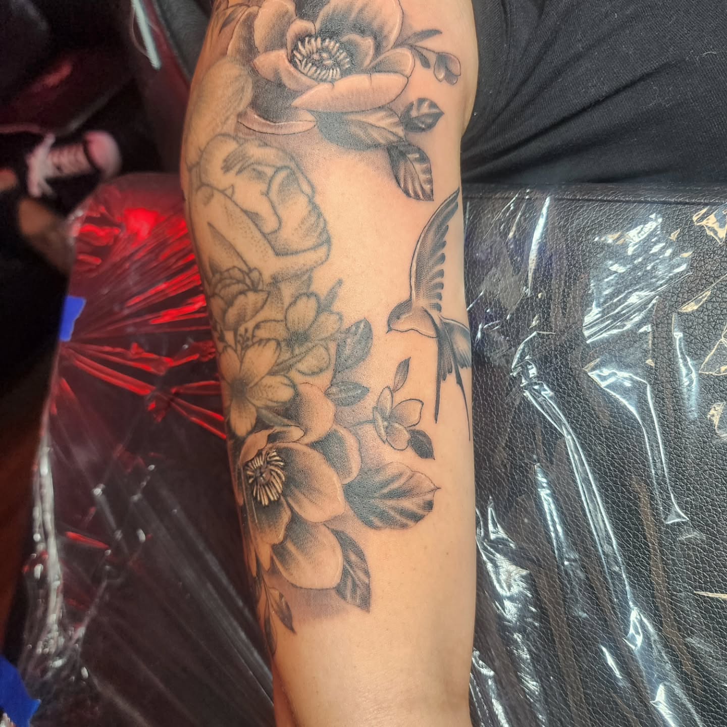 Floral arrangement black and grey tattoo on the forearm by Joe Garcia