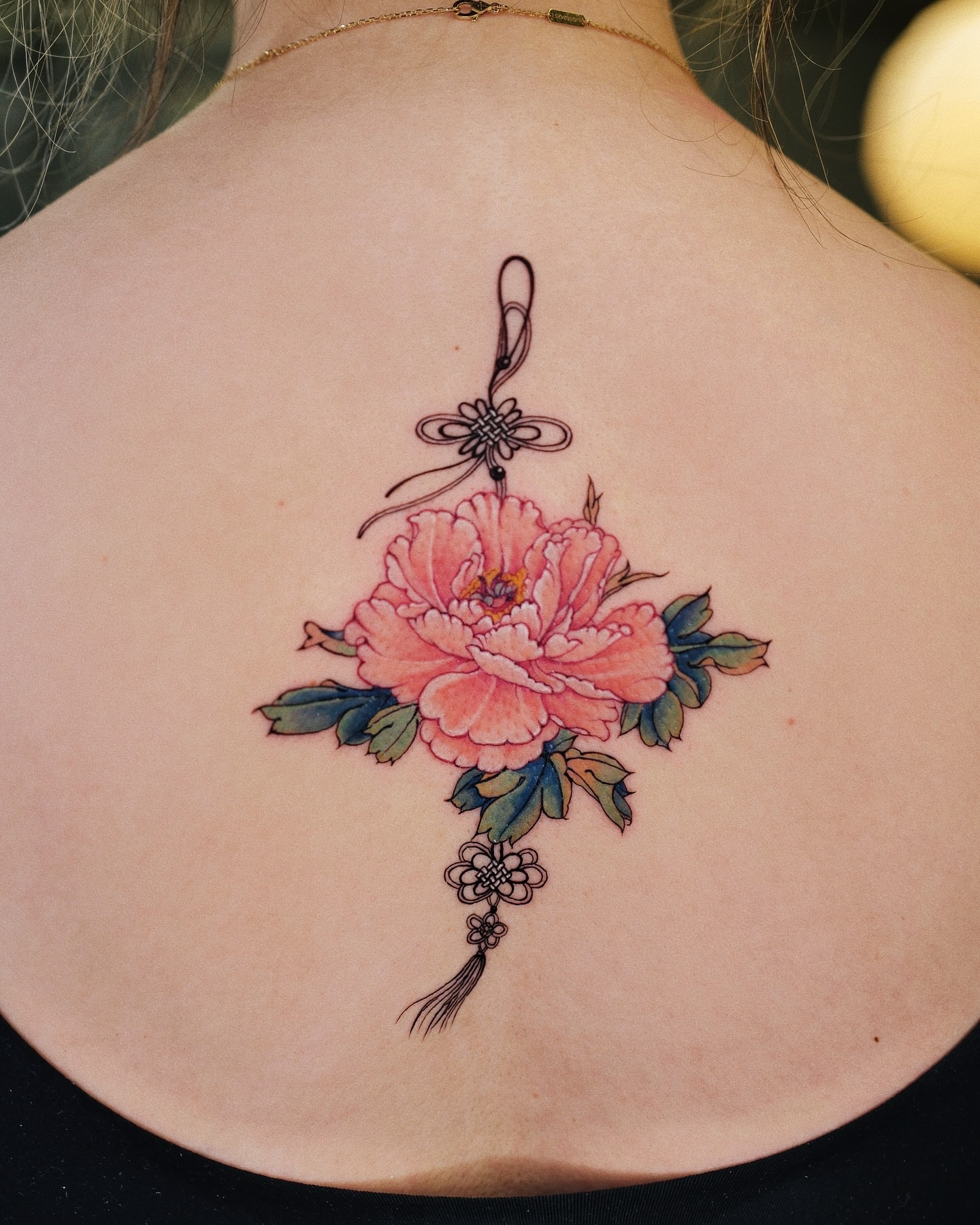 Peony and knot watercolor tattoo on the back by Seattle