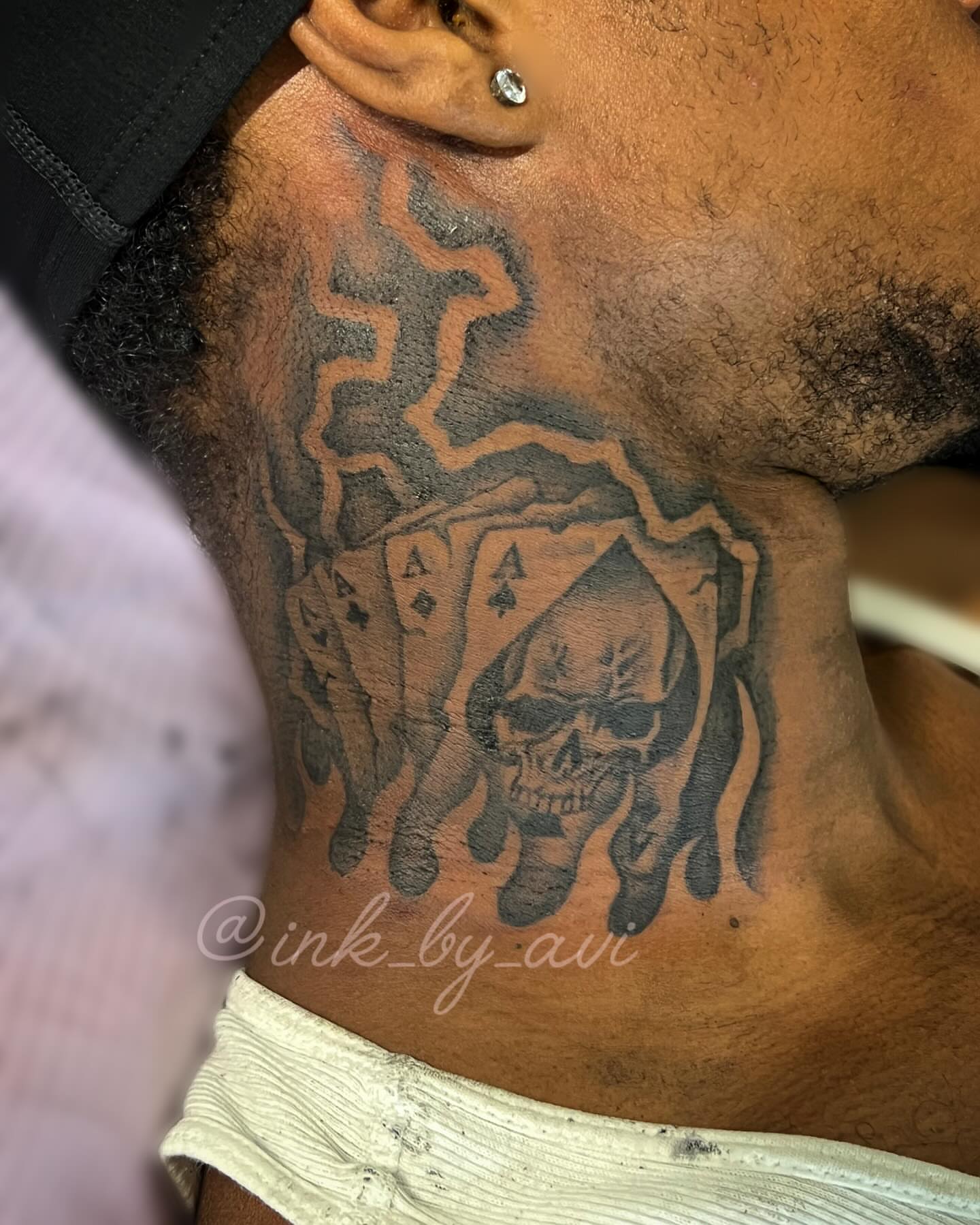 Skull and playing cards black and grey tattoo on the chest by Avi, Cleveland, Ohio