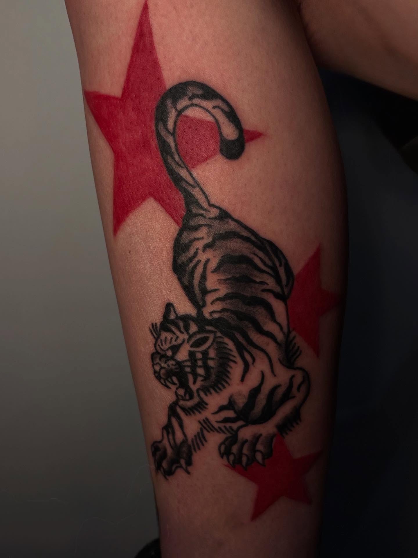 Tiger and stars American traditional tattoo on the forearm by Lee
