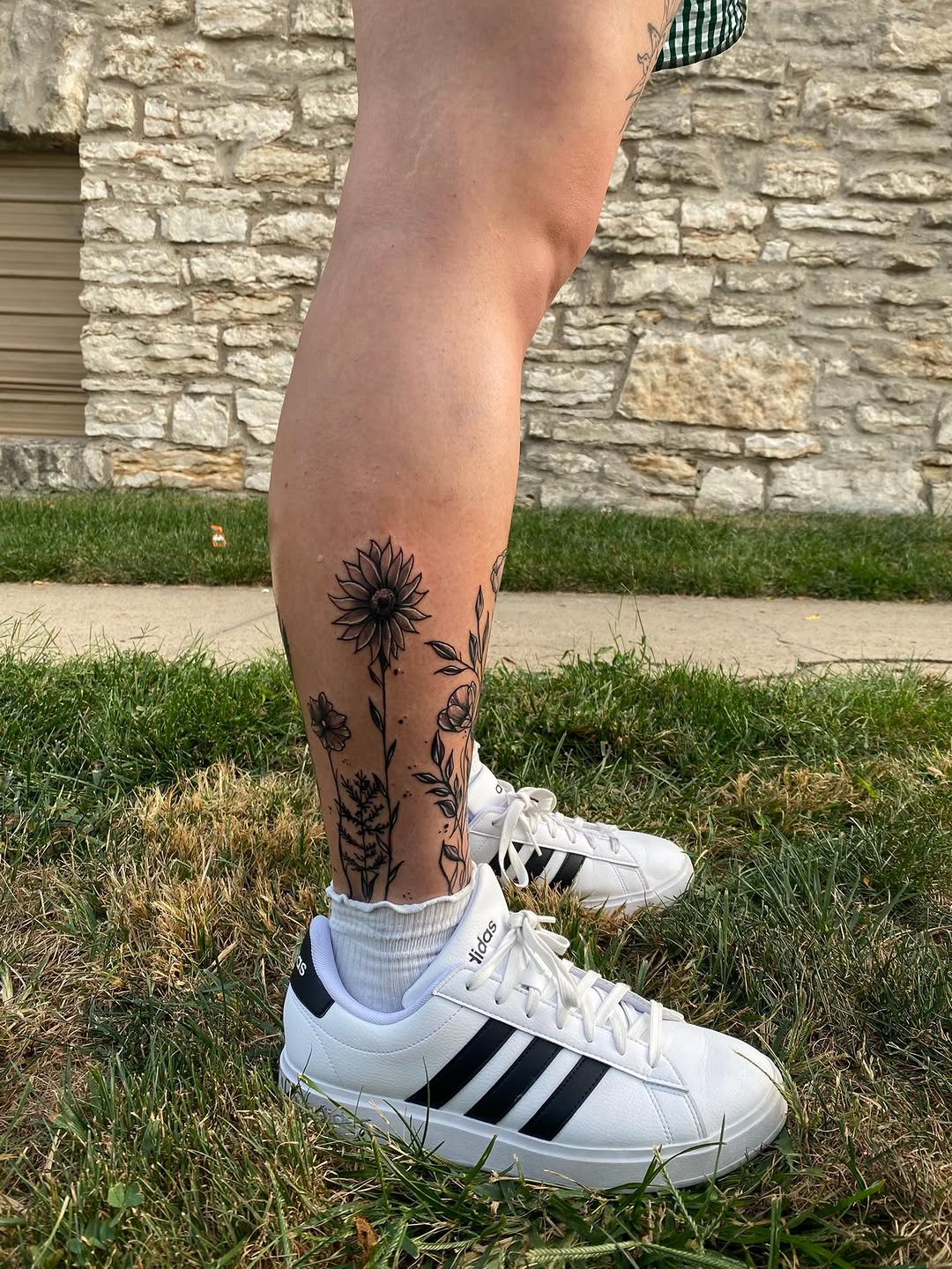Botanical flowers tattoo on the calf by Israel Jacob Woehler