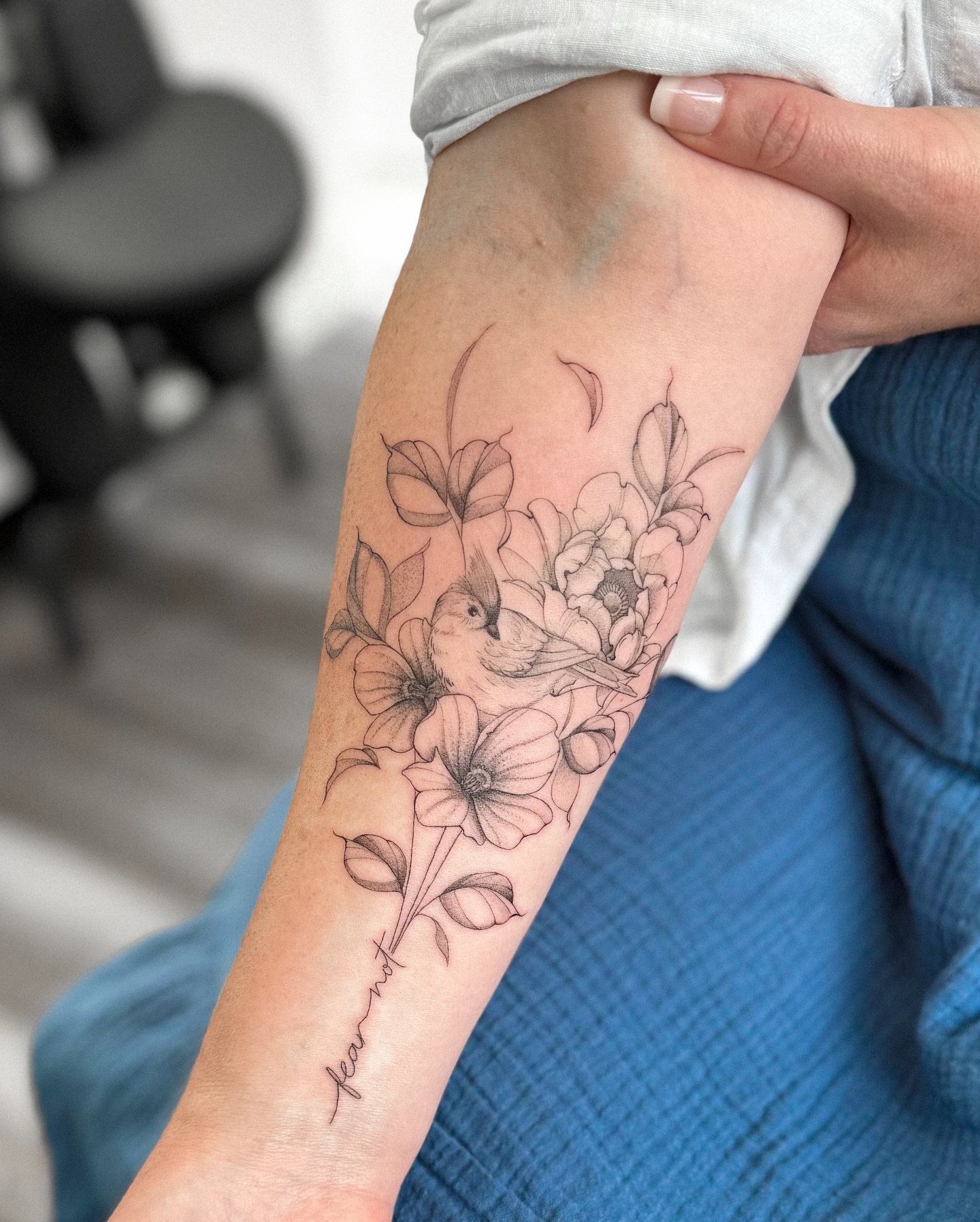Bird and flowers black and grey tattoo on the forearm by Daniel Montoya, Charlotte, North Carolina
