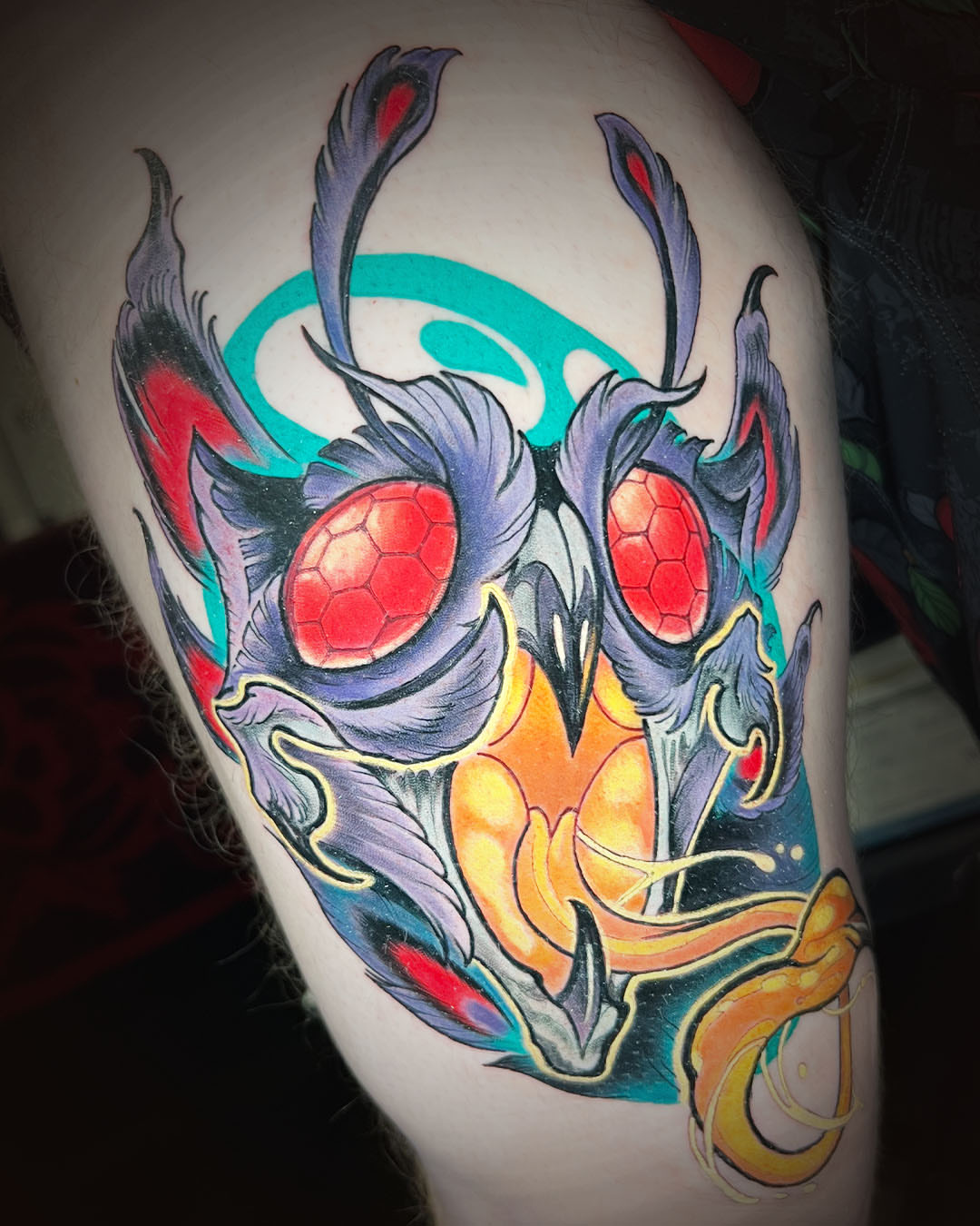 Mask geometric tattoo on the thigh by Kate Erso