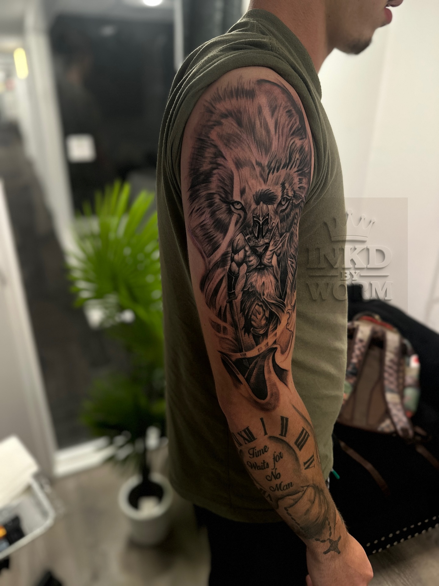 Lion and warrior realism tattoo on the forearm by ᴡᴏʀᴍ