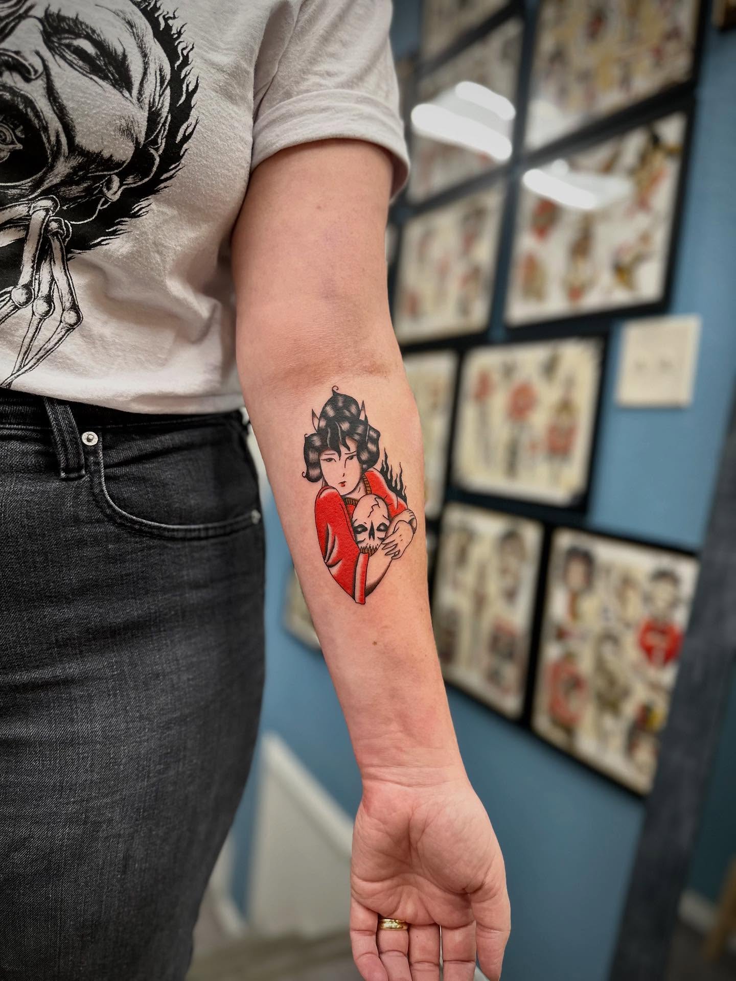 Woman holding skull American traditional tattoo on the forearm by rory
