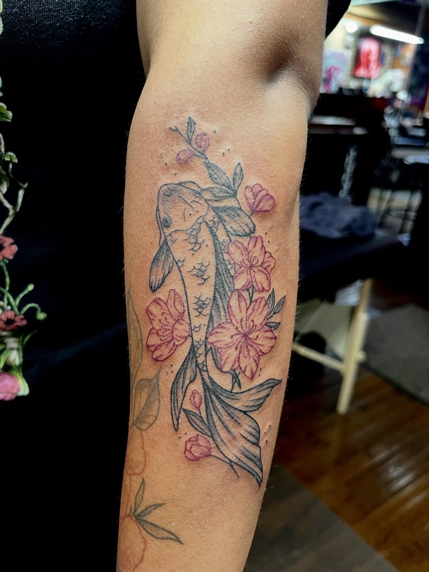 Rabbit and flowers American traditional tattoo on the forearm by Kenny Buck