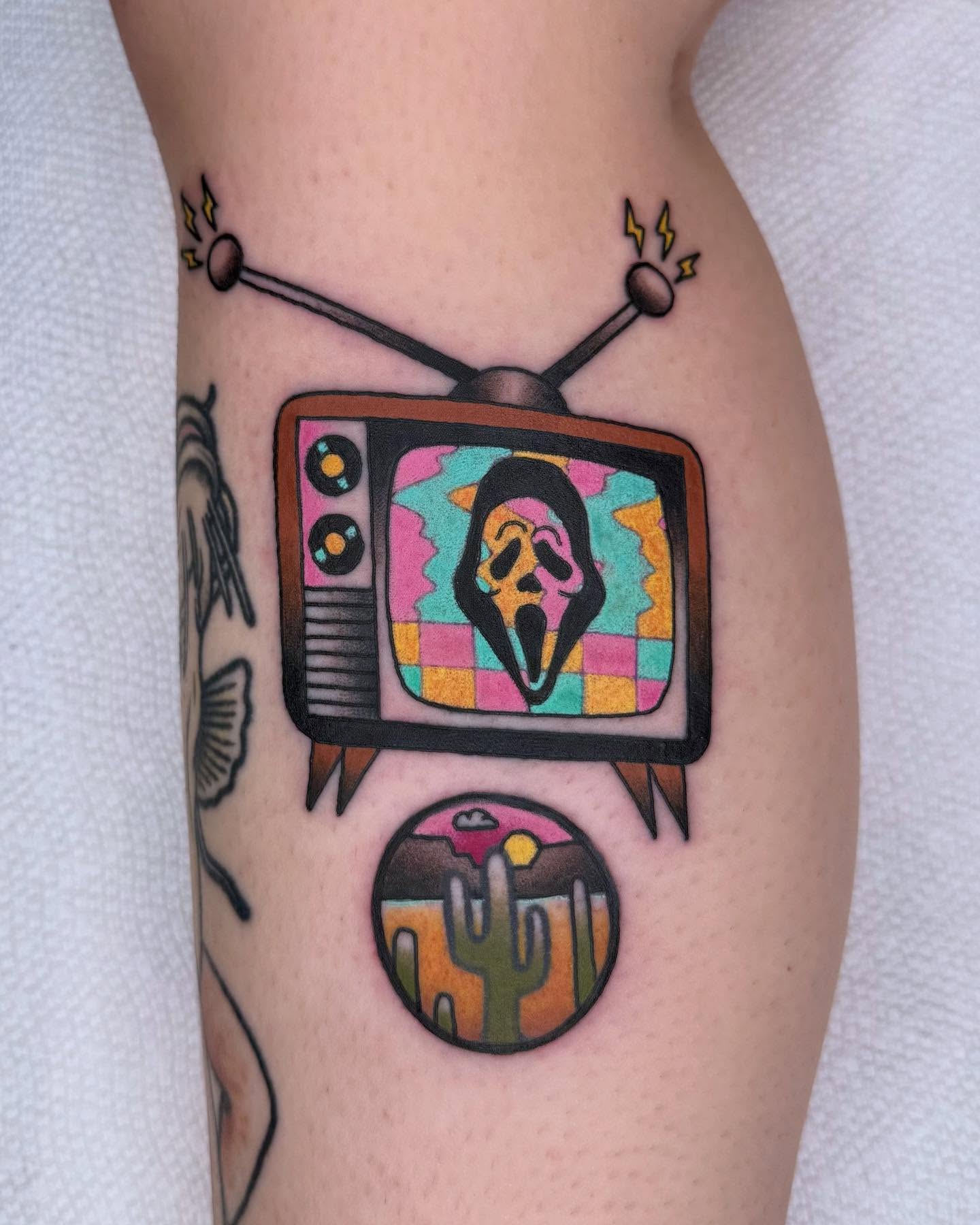 TV with ghost mask American traditional tattoo on the forearm by Curtis Stairs, Seattle, Washington