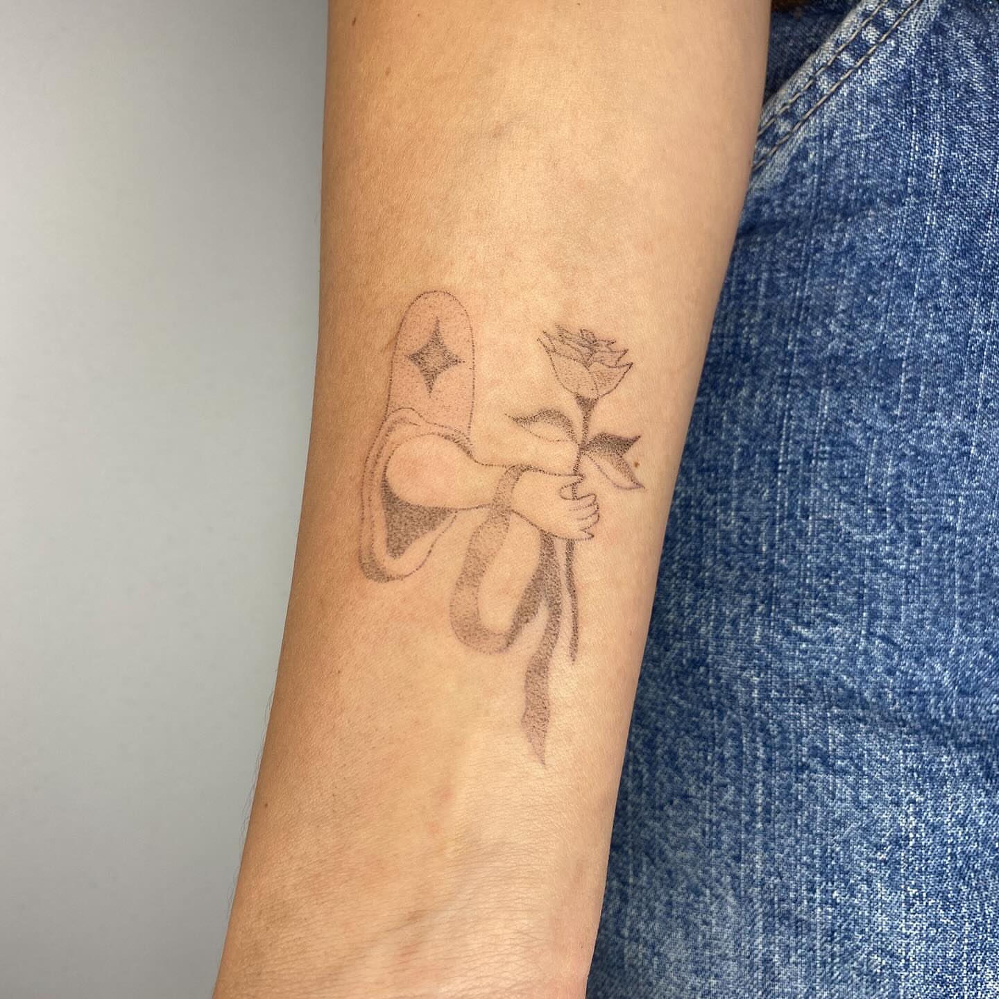Angel holding rose black and grey tattoo on the forearm by 🌀☁️kath☁️🥀