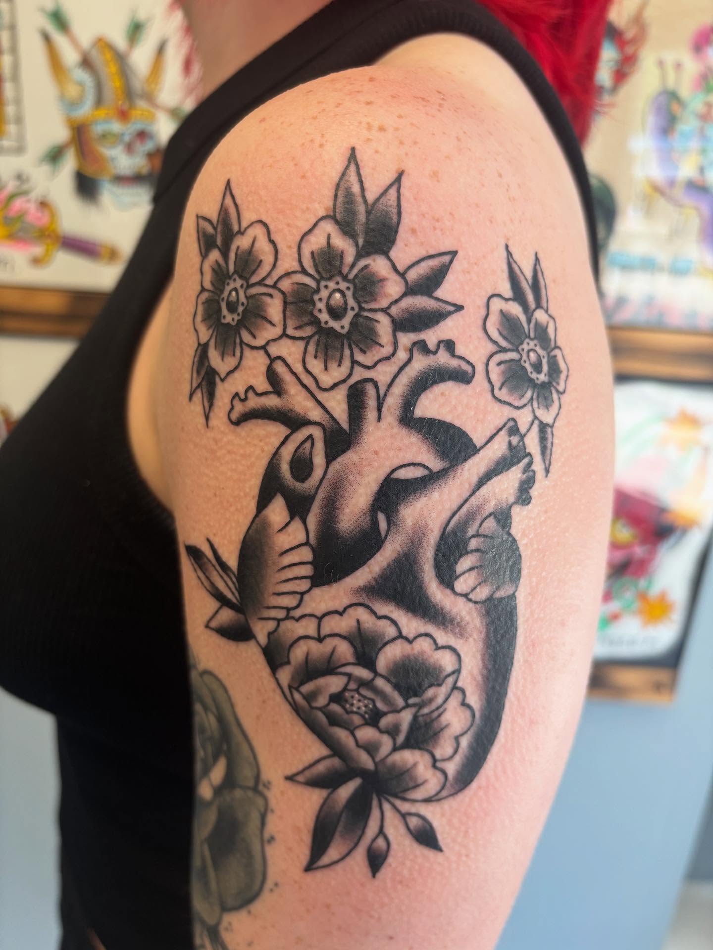 Anatomical heart with flowers American traditional tattoo on the shoulder by Ben Whyte