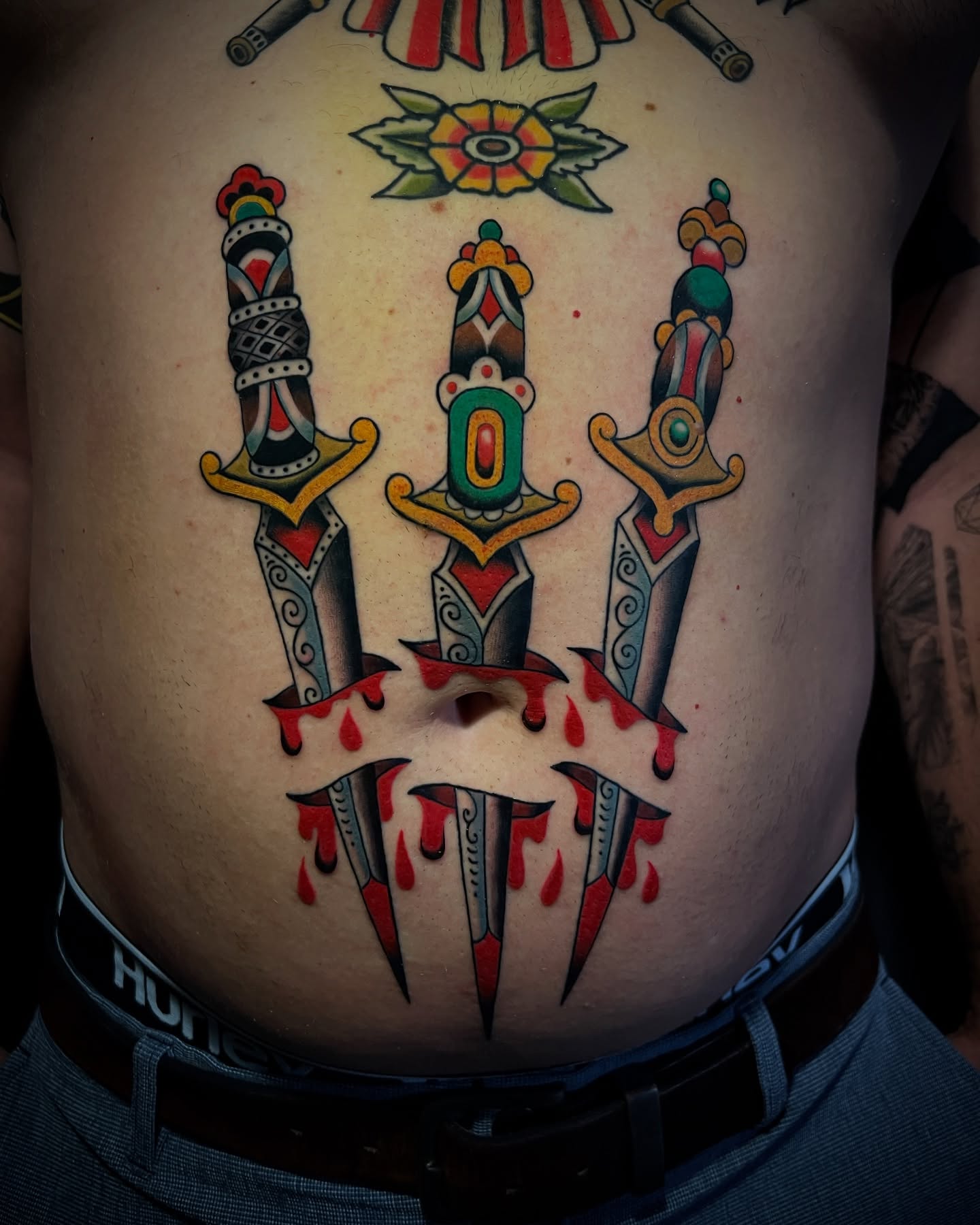 Knives and claws American traditional tattoo on the torso by Michael Munter, Philadelphia, Pennsylvania
