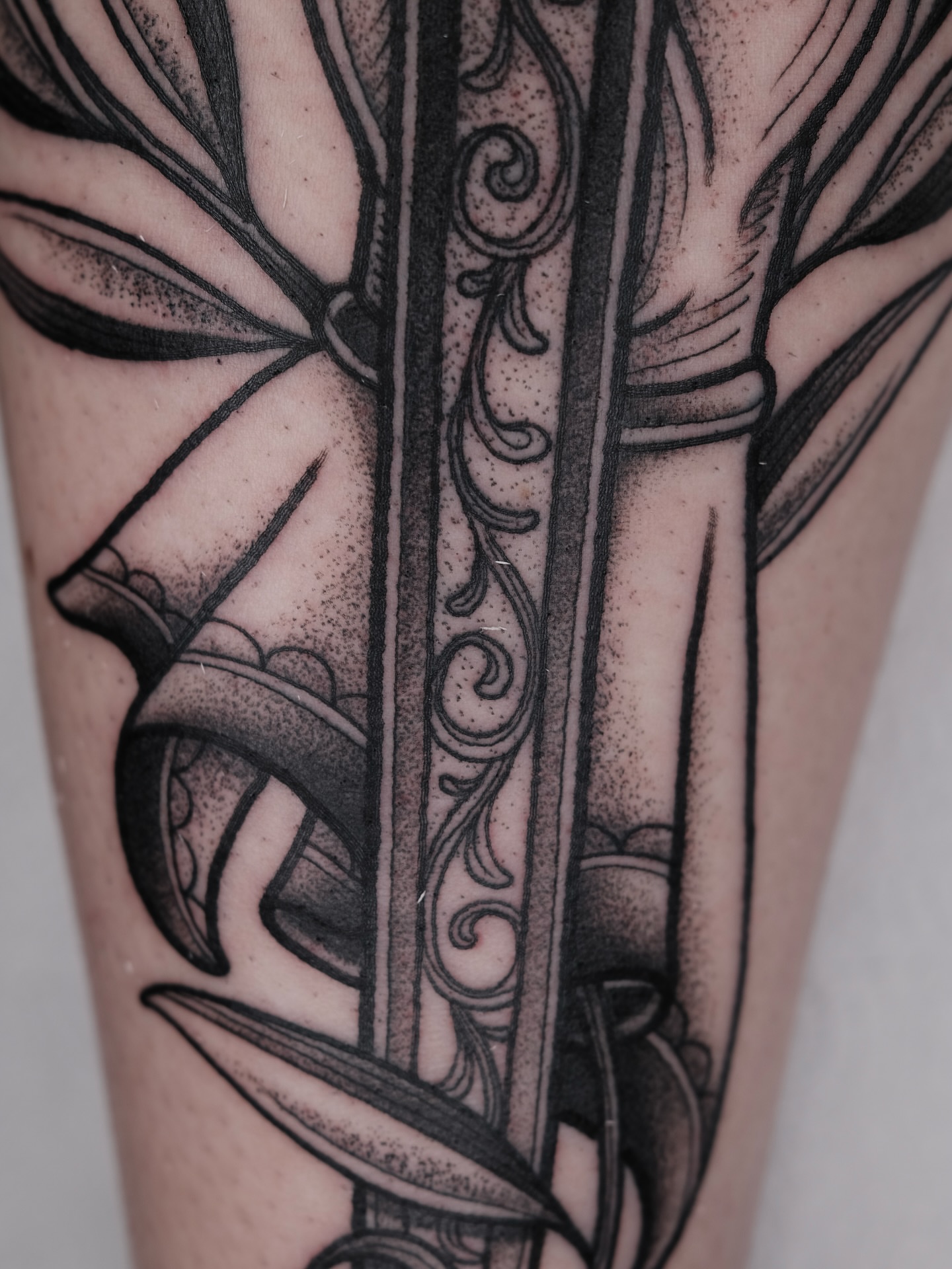 Sword geometric tattoo on the forearm by Kyle Patrick