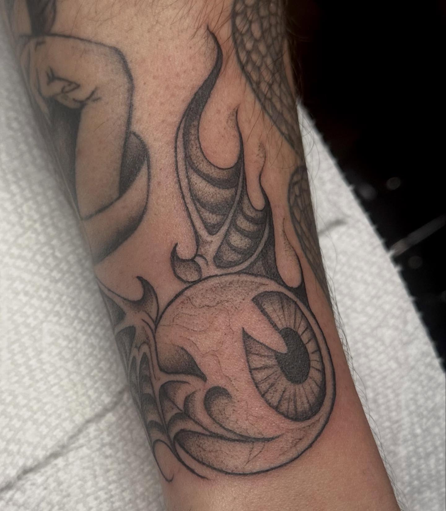 Eye and flame realism tattoo on the forearm by Lia Massari