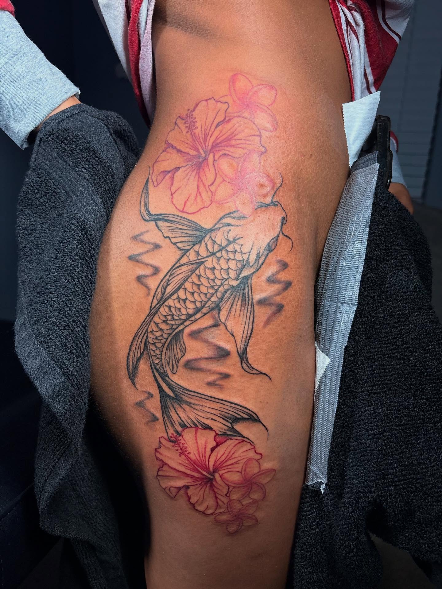 Koi fish and hibiscus flowers realism tattoo on the thigh by Bay Area Tattoo Artist ✍🏽
