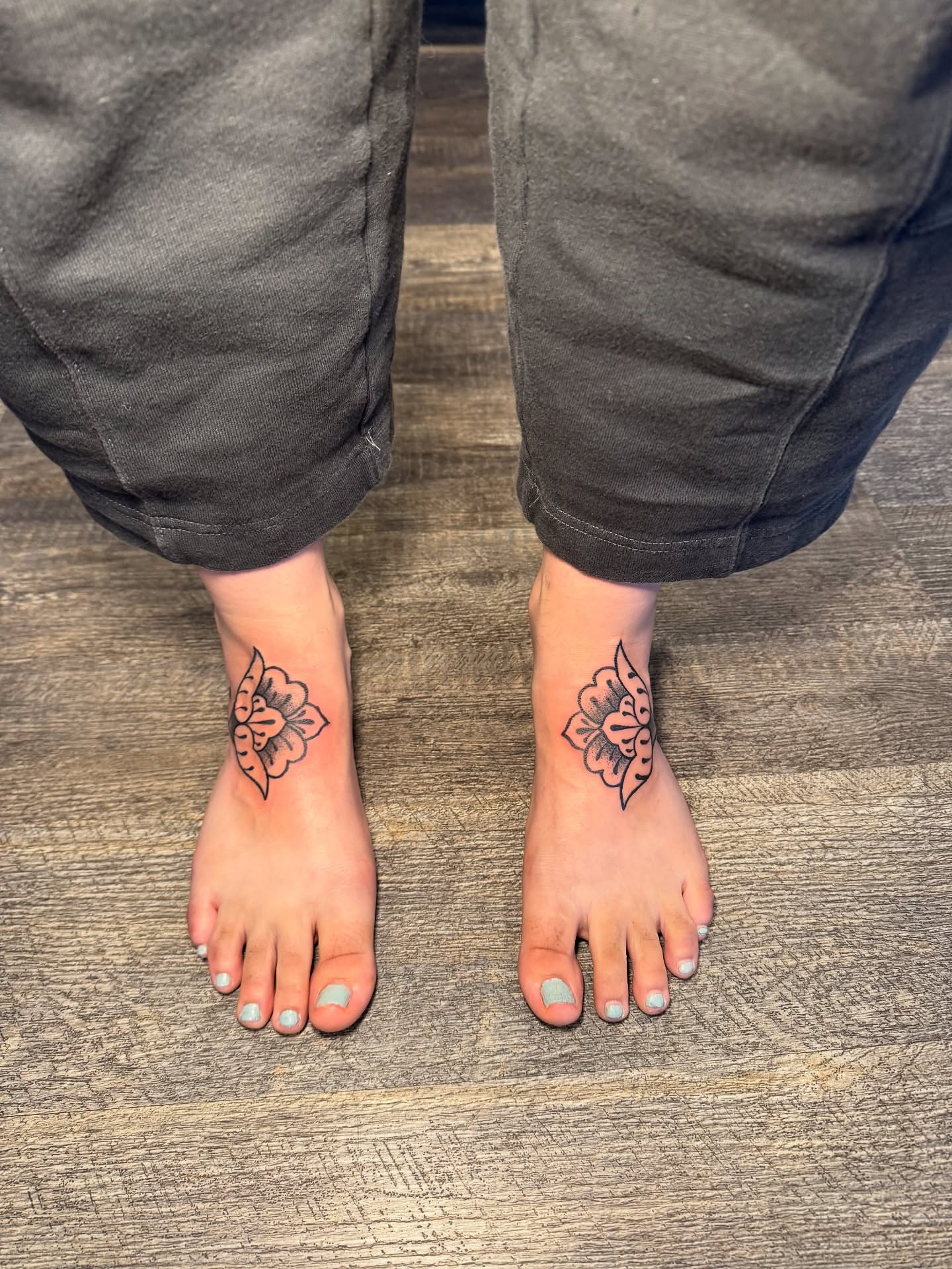 Floral design black and grey tattoo on the foot by Kinzi Brown