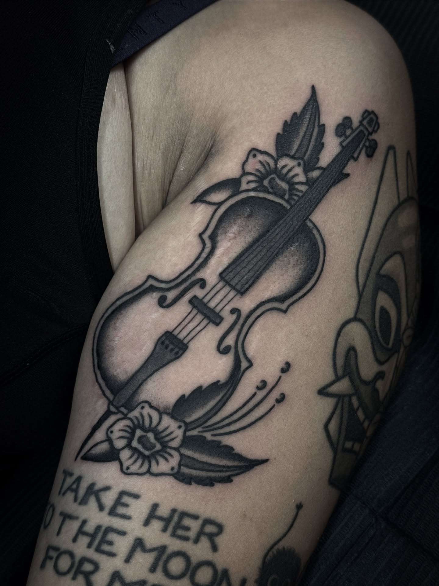 Violin and flowers American traditional tattoo on the shoulder by Ally noel