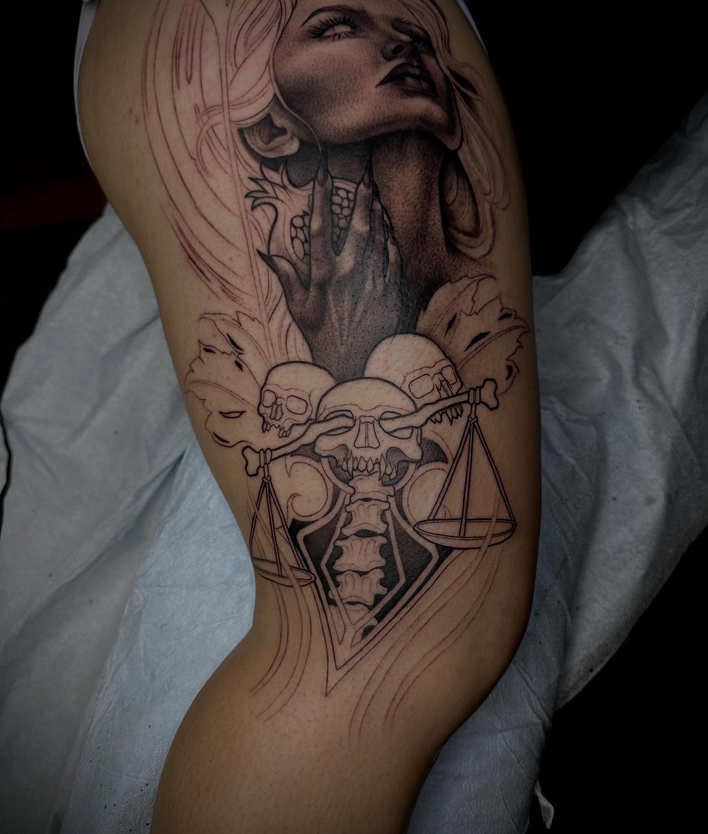 Woman with skulls realism tattoo on the thigh by Madison Orchard Tattoos