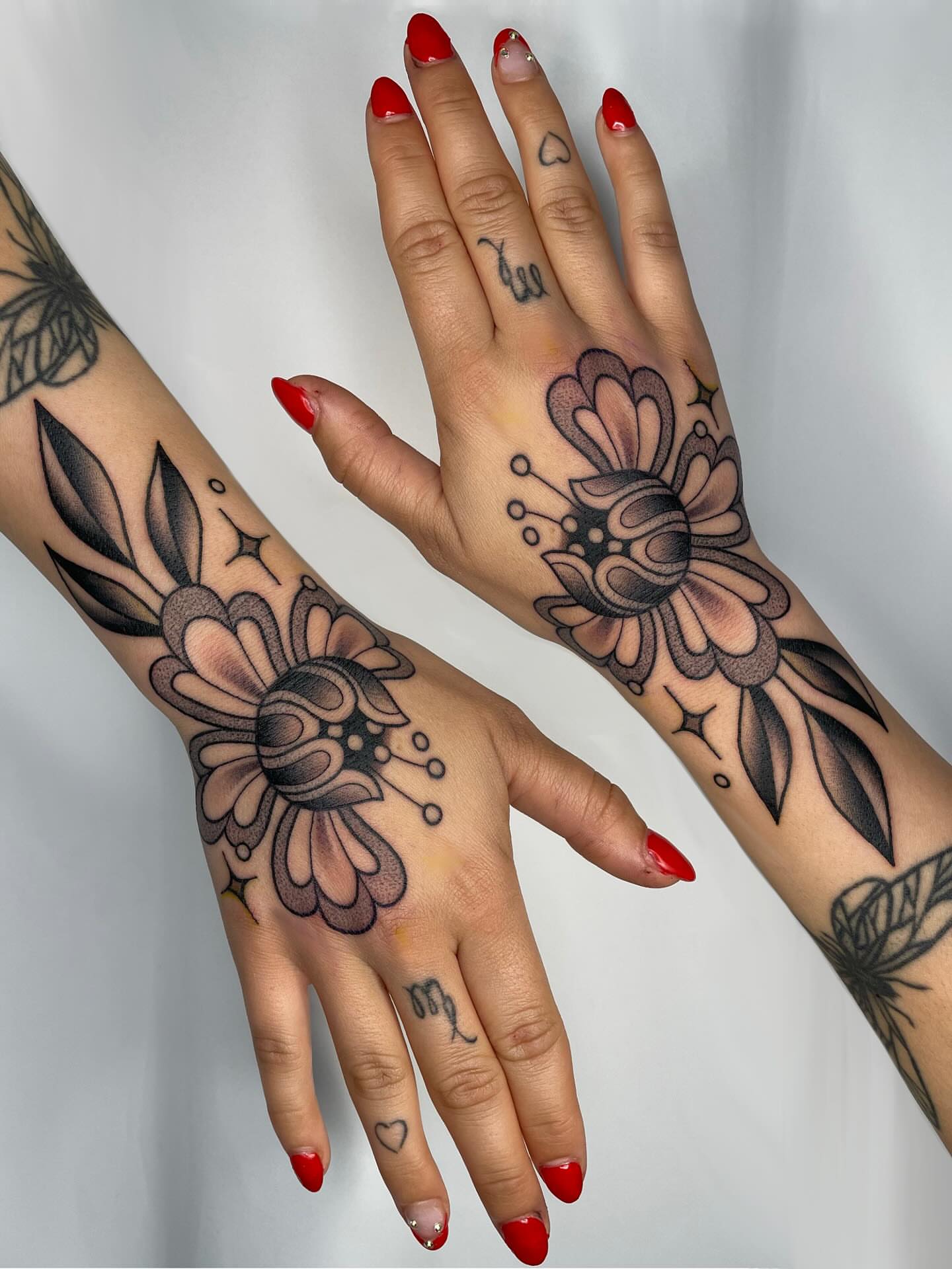 Floral design American traditional tattoo on the hand by Victoria Bacon