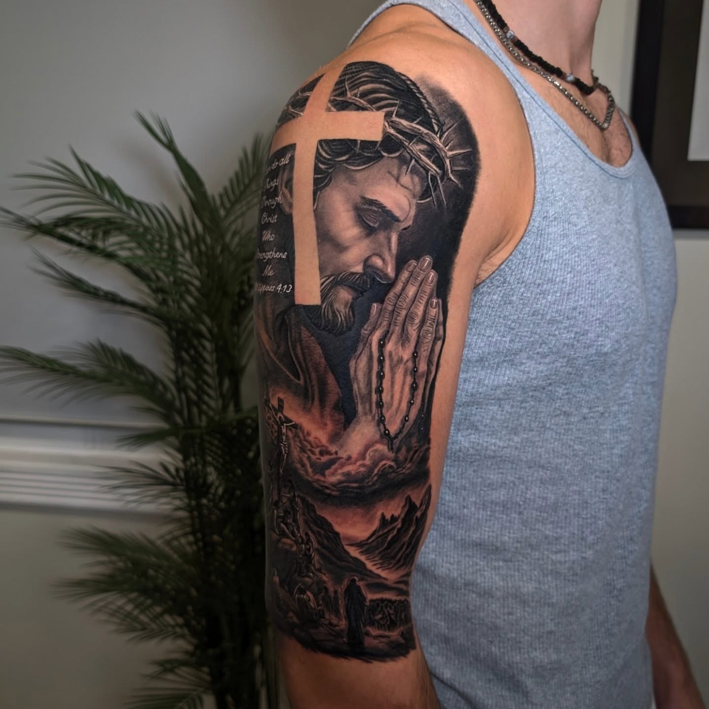 Praying jesus realism tattoo on the upper arm by Antonio Arias