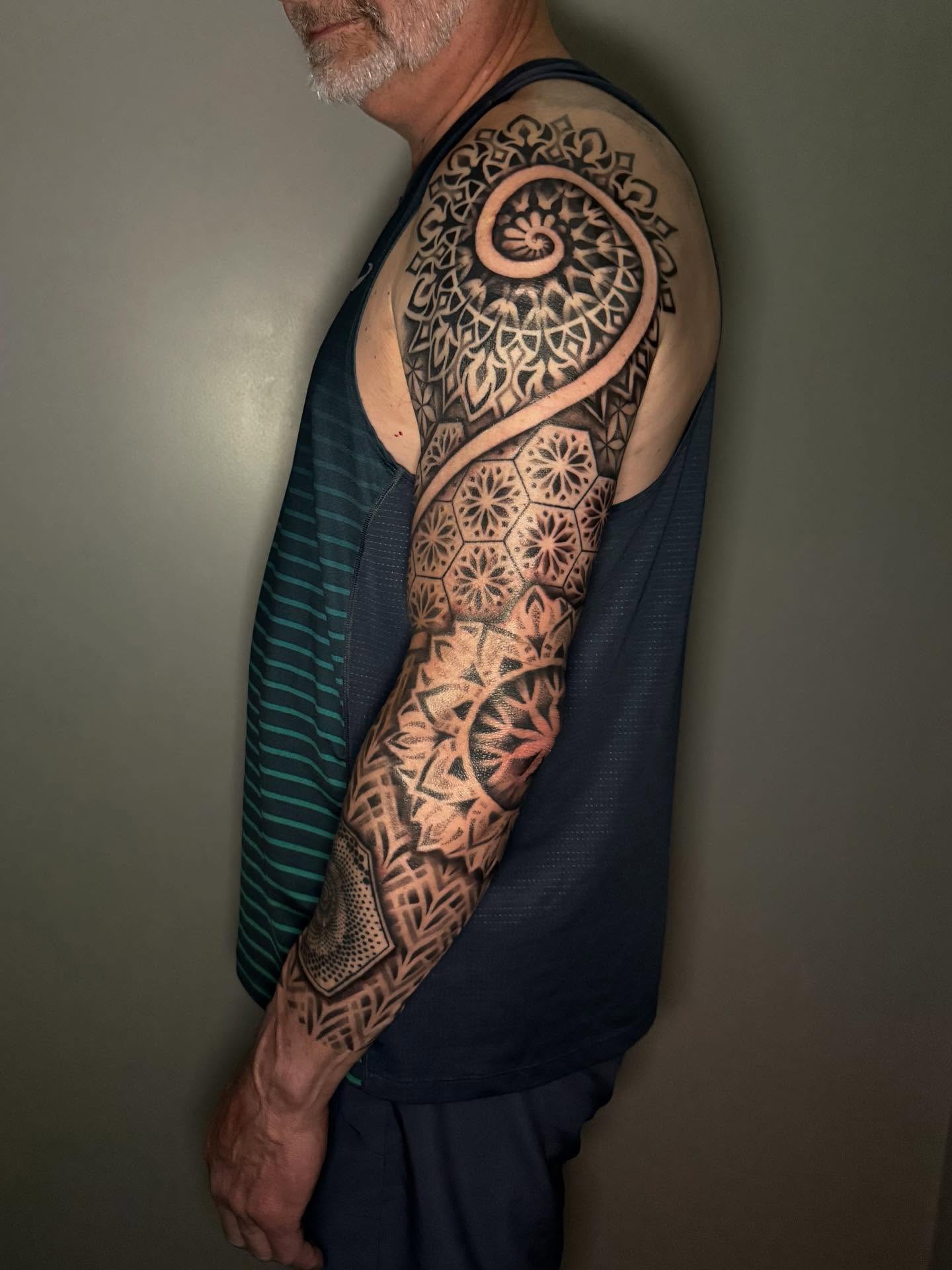 Geometric mandala geometric tattoo on the upper arm by Diana Guillette