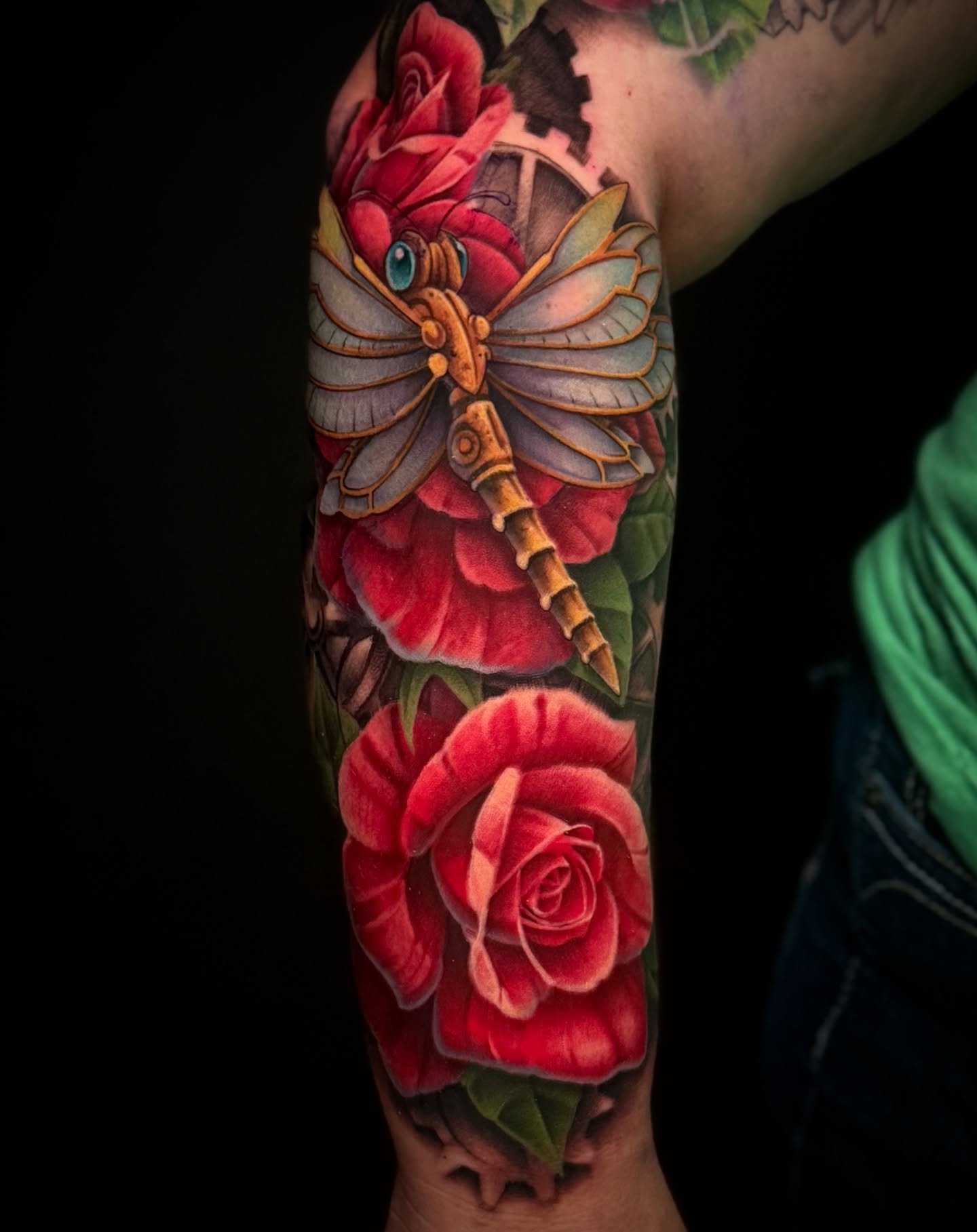 Mechanical dragonfly with roses realism tattoo on the forearm by James Hall