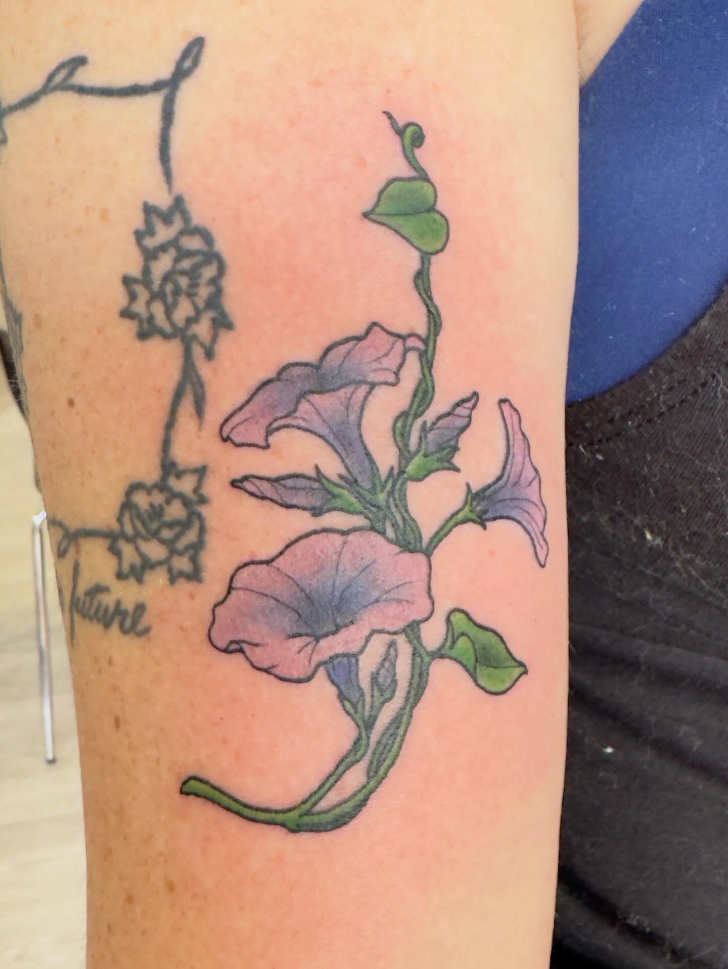 Morning glory flowers watercolor tattoo on the forearm by Patrick Carroll
