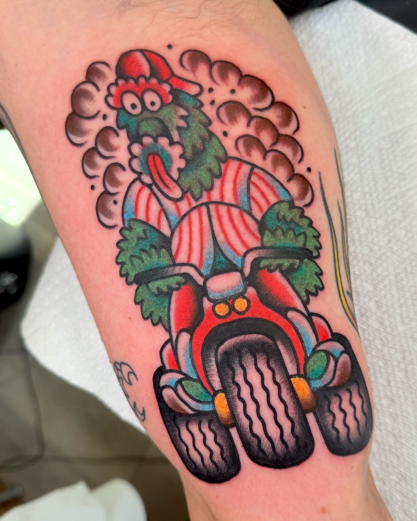 Christmas gnome on motorcycle American traditional tattoo on the thigh by Cullen Bleser Quinn