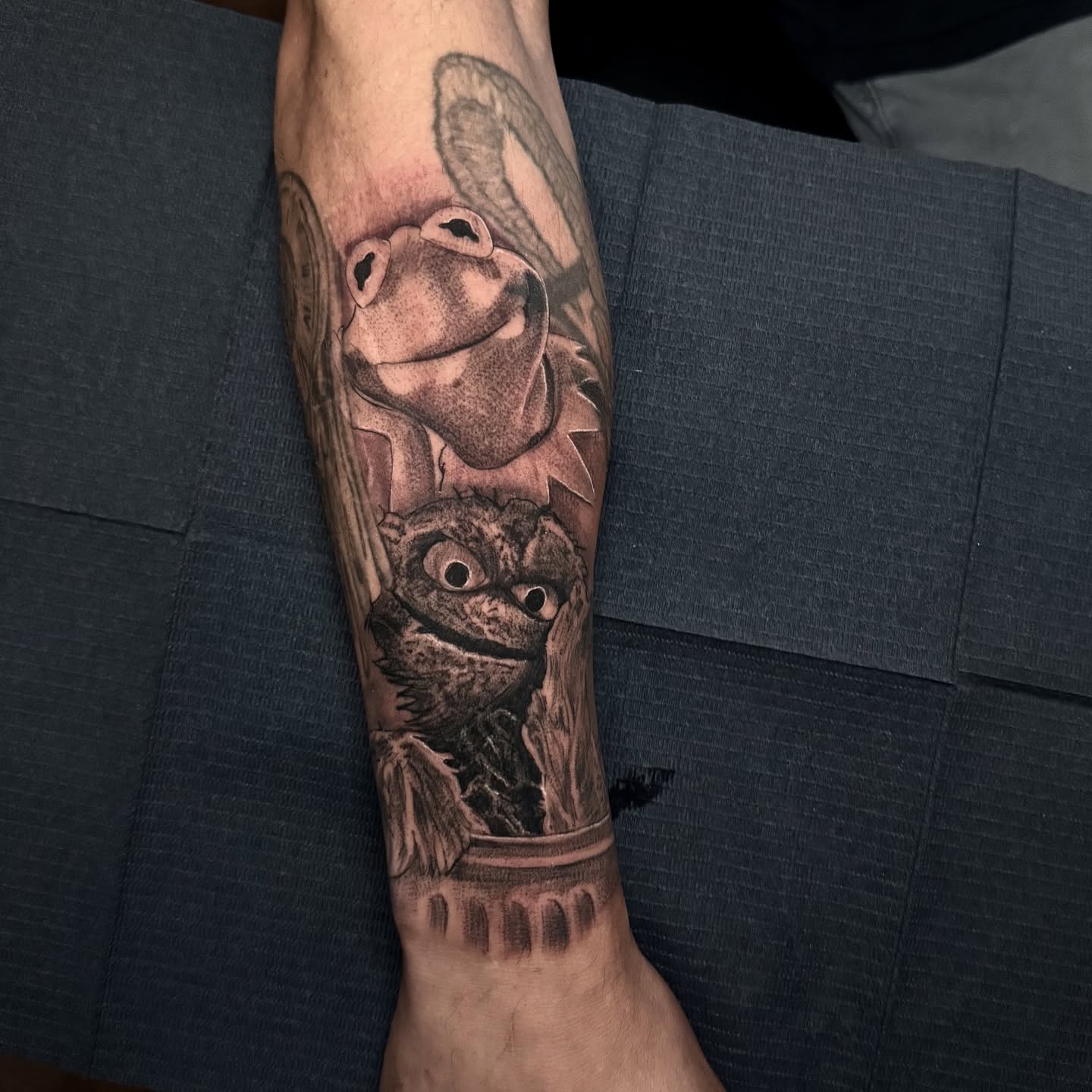 Frog and raccoon realism tattoo on the forearm by Tattoo Artist