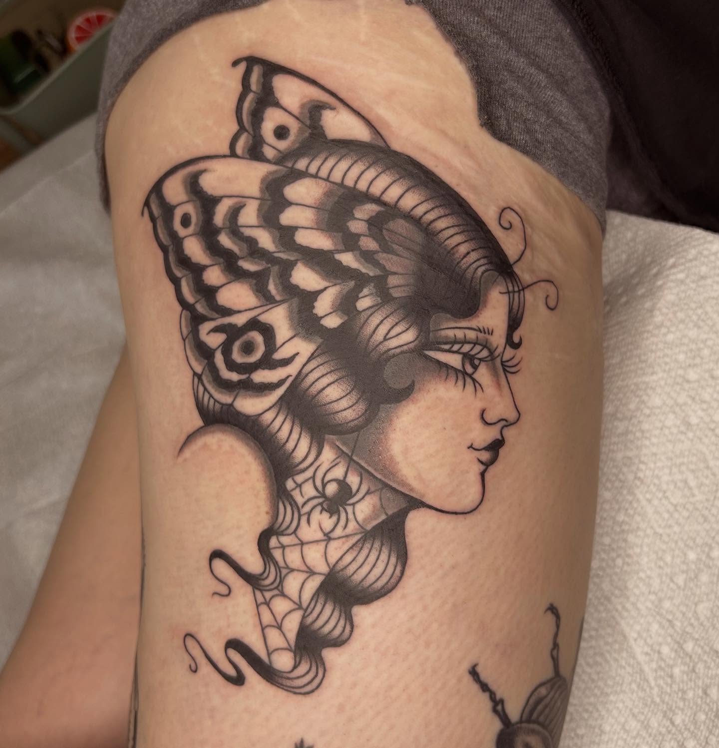 Woman with butterfly black and grey tattoo on the upper arm by ☻ darby robertson ☻