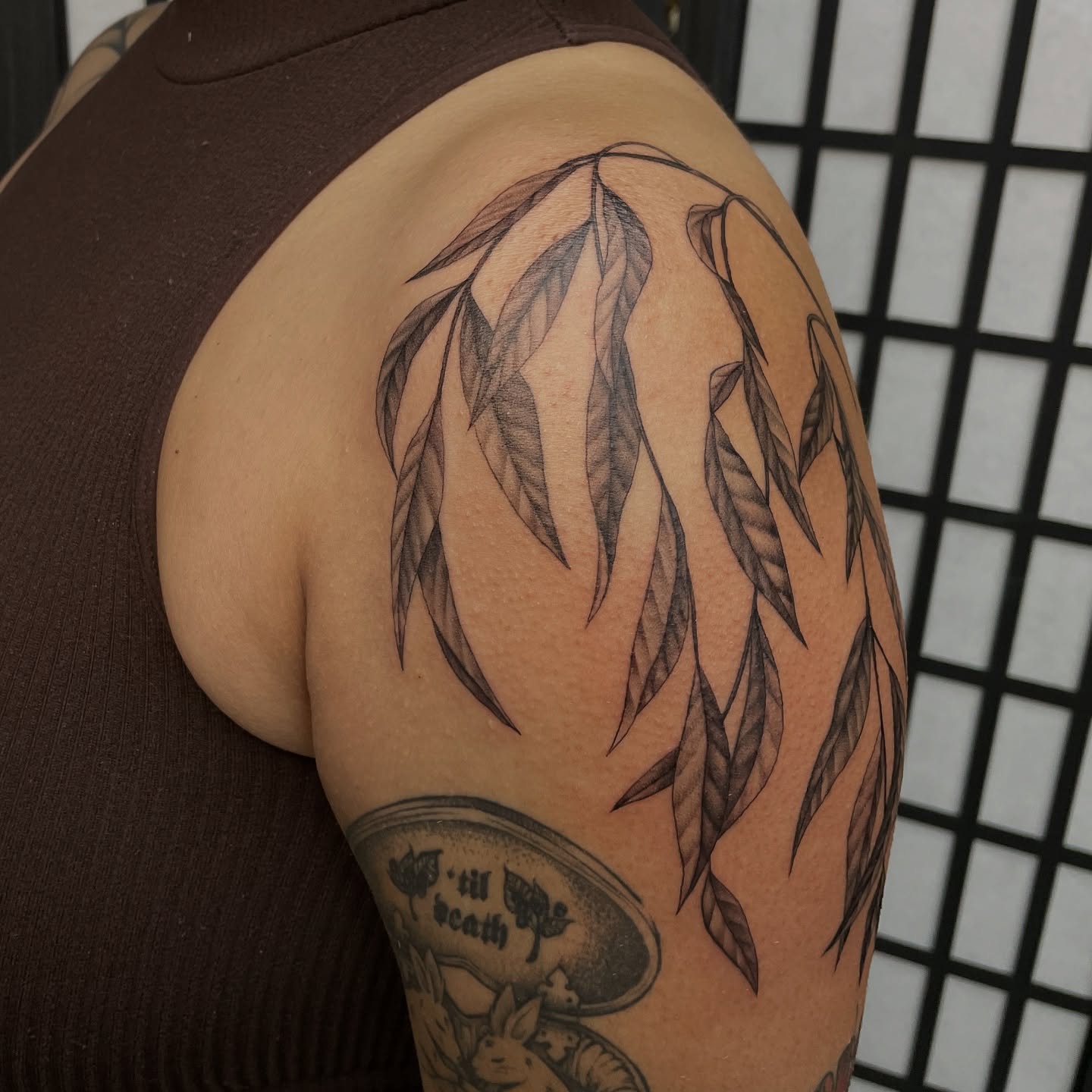 Weeping willow leaves black and grey tattoo on the shoulder by kaylee