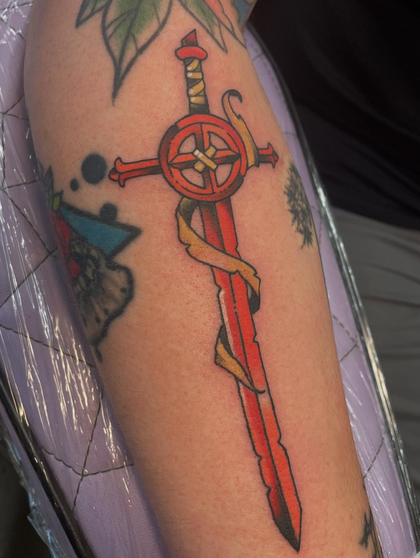 Sword American traditional tattoo on the forearm by Fionna Fanning