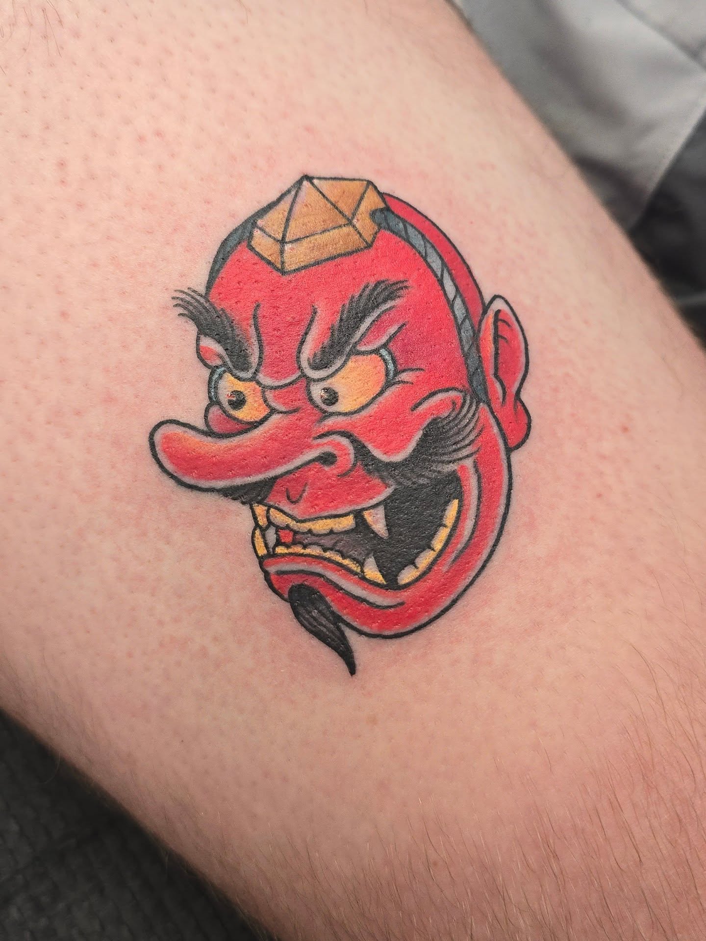 Demon mask American traditional tattoo on the forearm by Joseph Jeffers