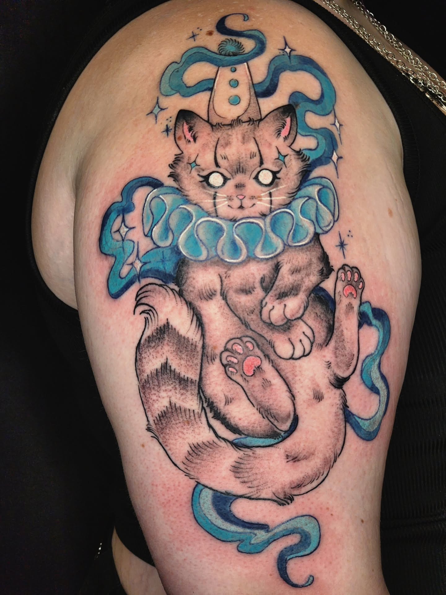 Cat with ruff new school tattoo on the shoulder by Audrey Luther