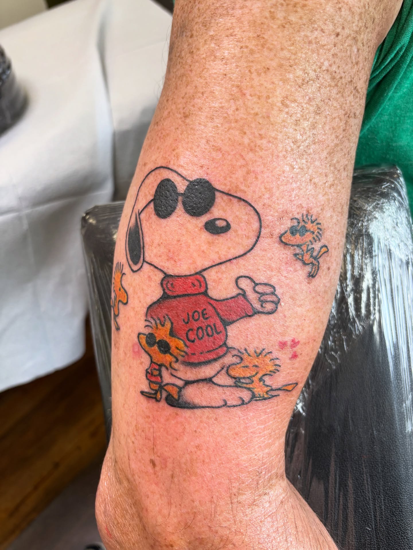 Snoopy American traditional tattoo on the forearm by Mike DiCicco