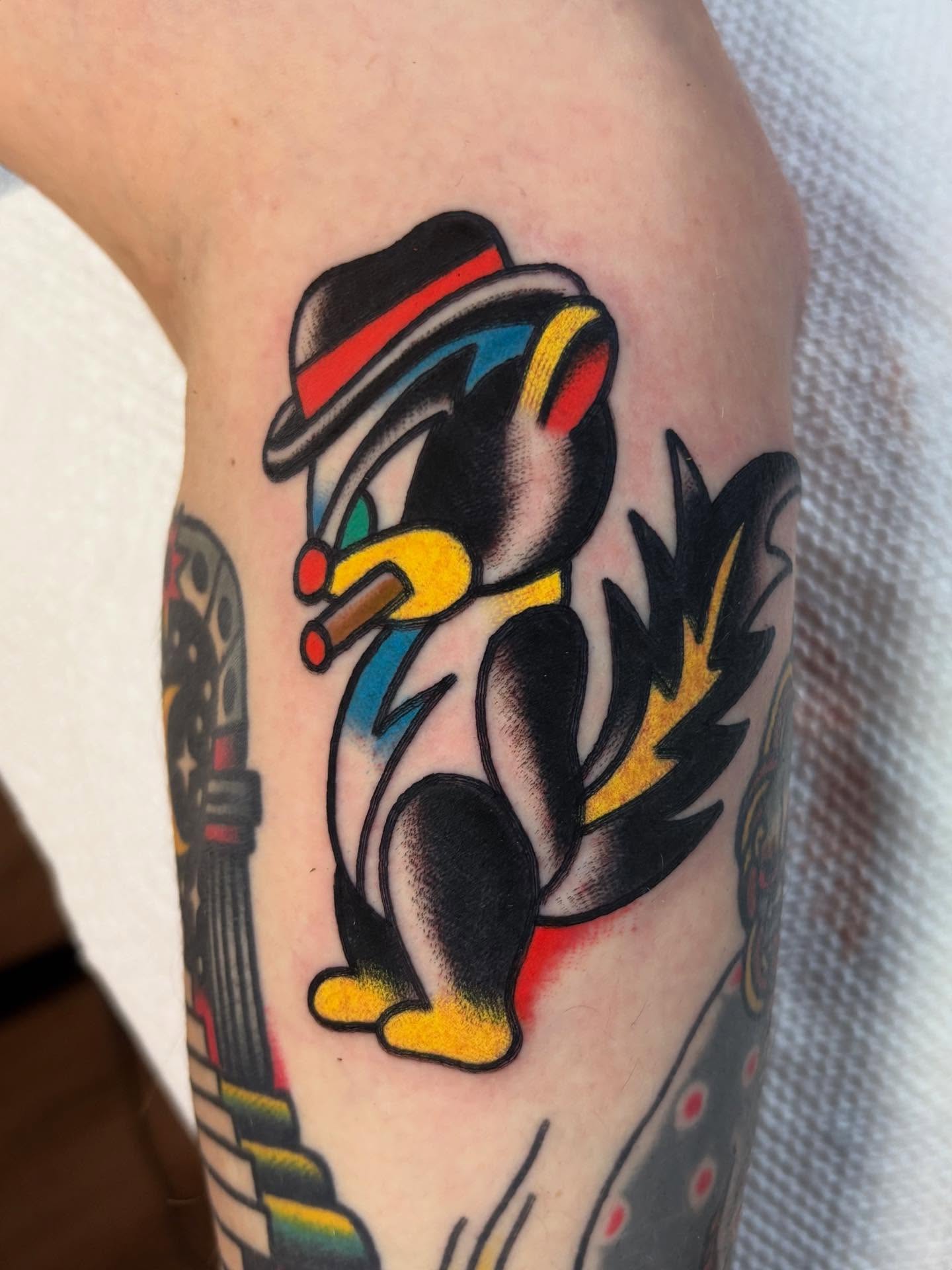 Penguin American traditional tattoo on the forearm by Traditional Tattooing