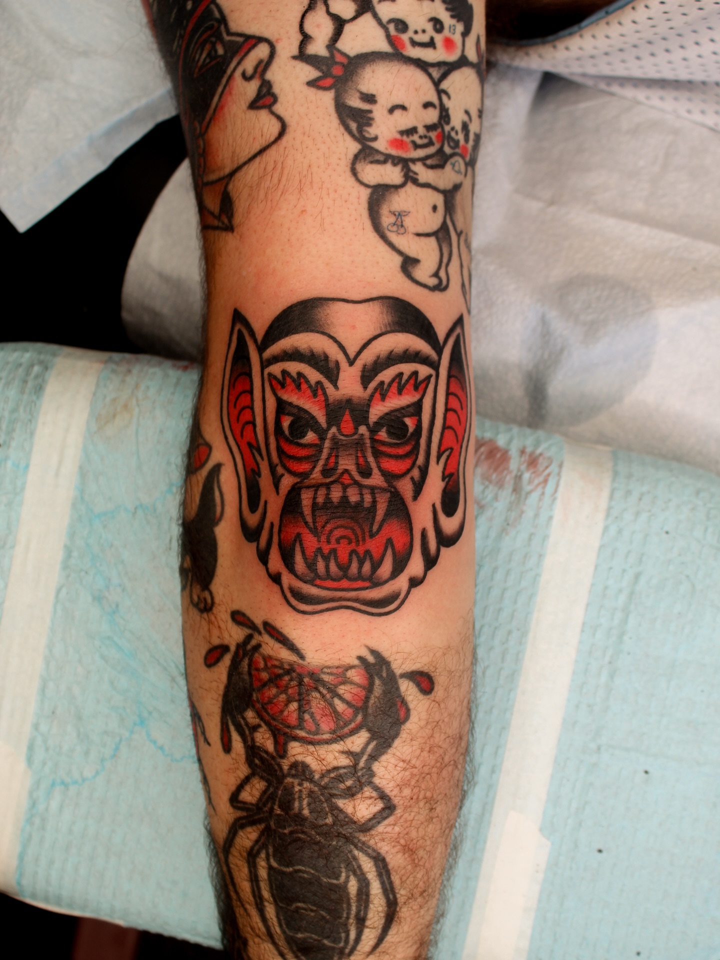 Demon mask American traditional tattoo on the forearm by Kehrmie Tattoos, Berkeley, California