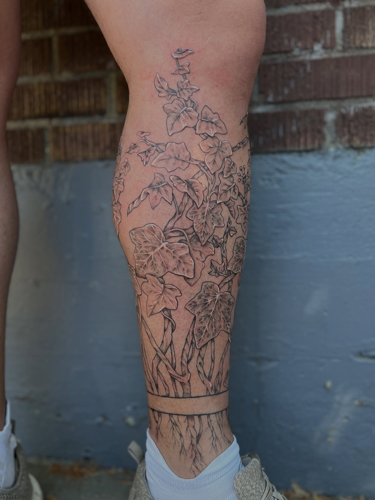 Ivy and flowers black and grey tattoo on the calf by Kelsi Hooper, Seattle, Washington